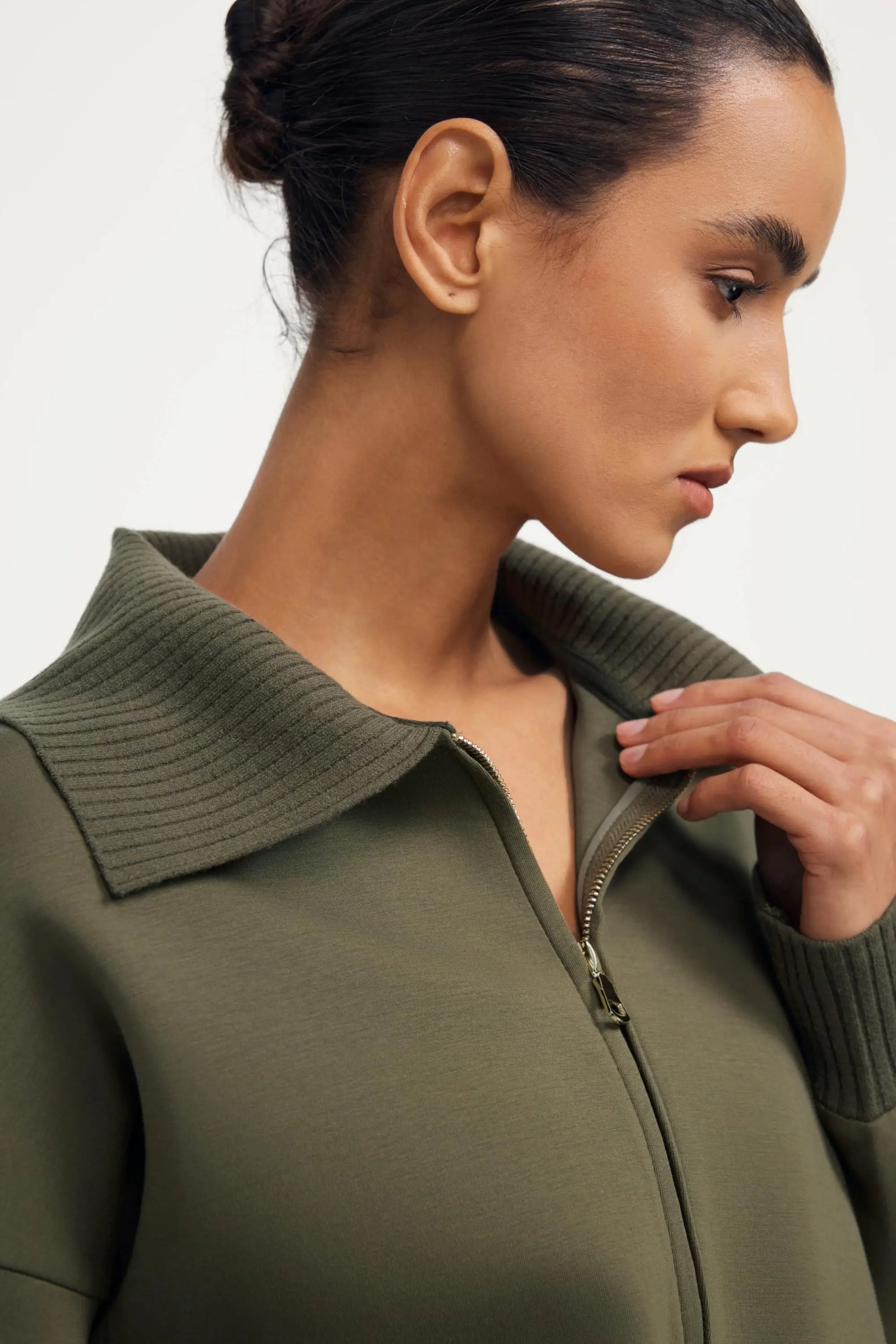 Close-up collar detail of women’s olive taupe cropped knit zip jacket
