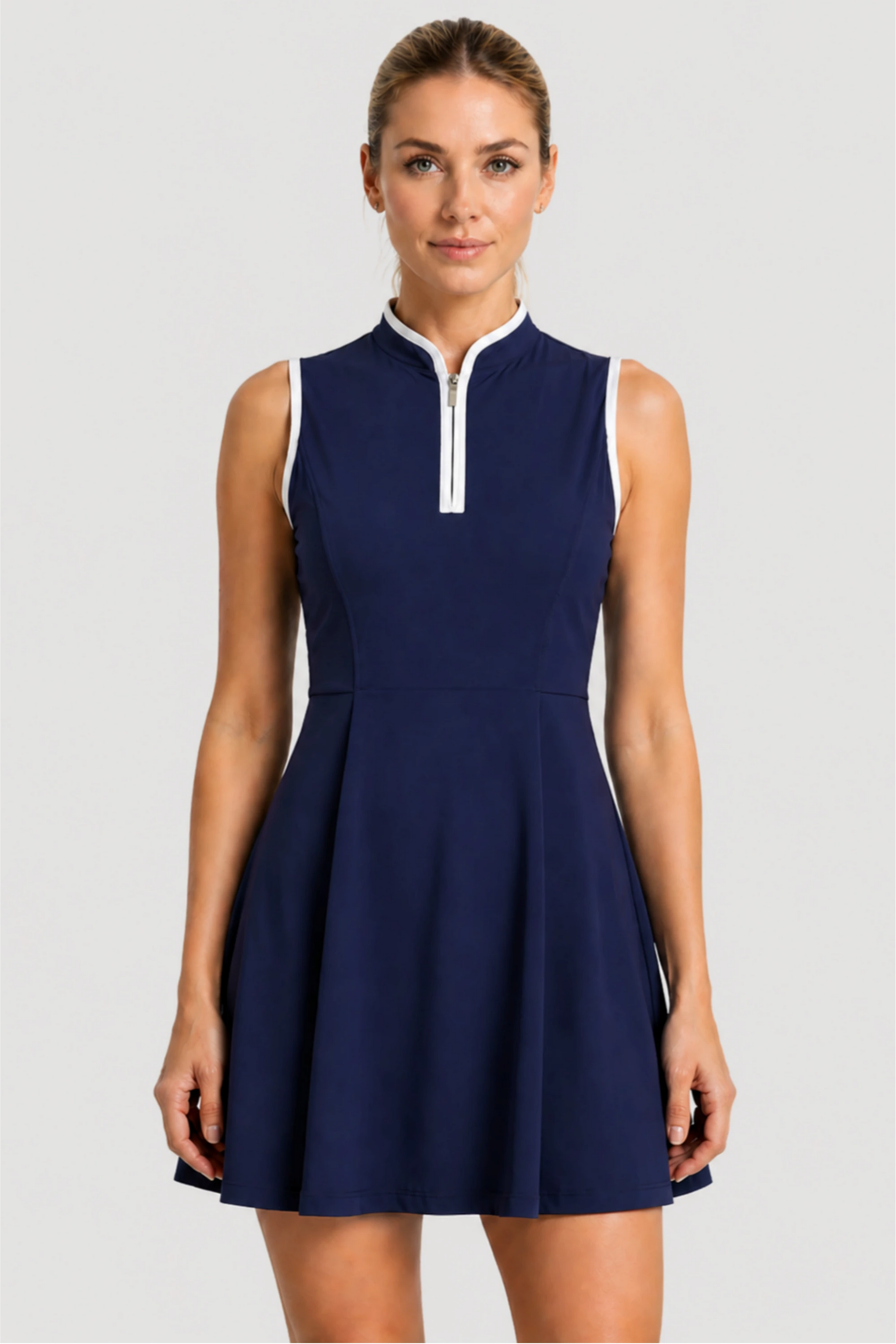 Women’s sleeveless performance golf dress in Midnight Swing with sculpted waist and zip neckline