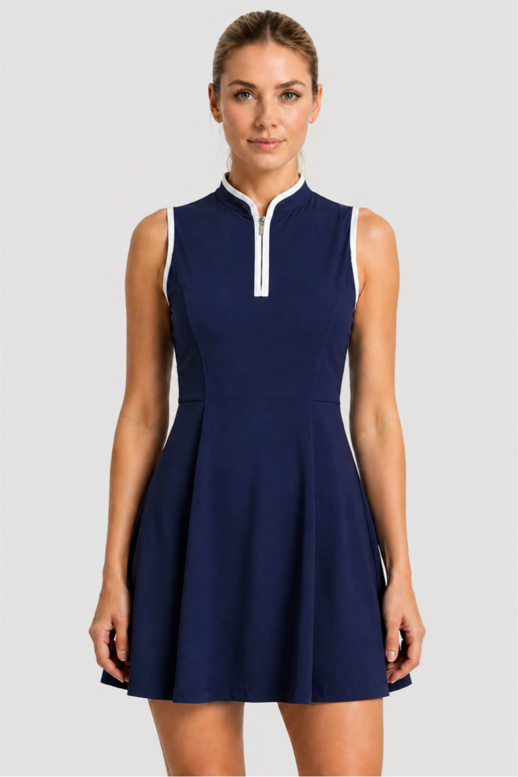 Women’s sleeveless performance golf dress in Midnight Swing with sculpted waist and zip neckline