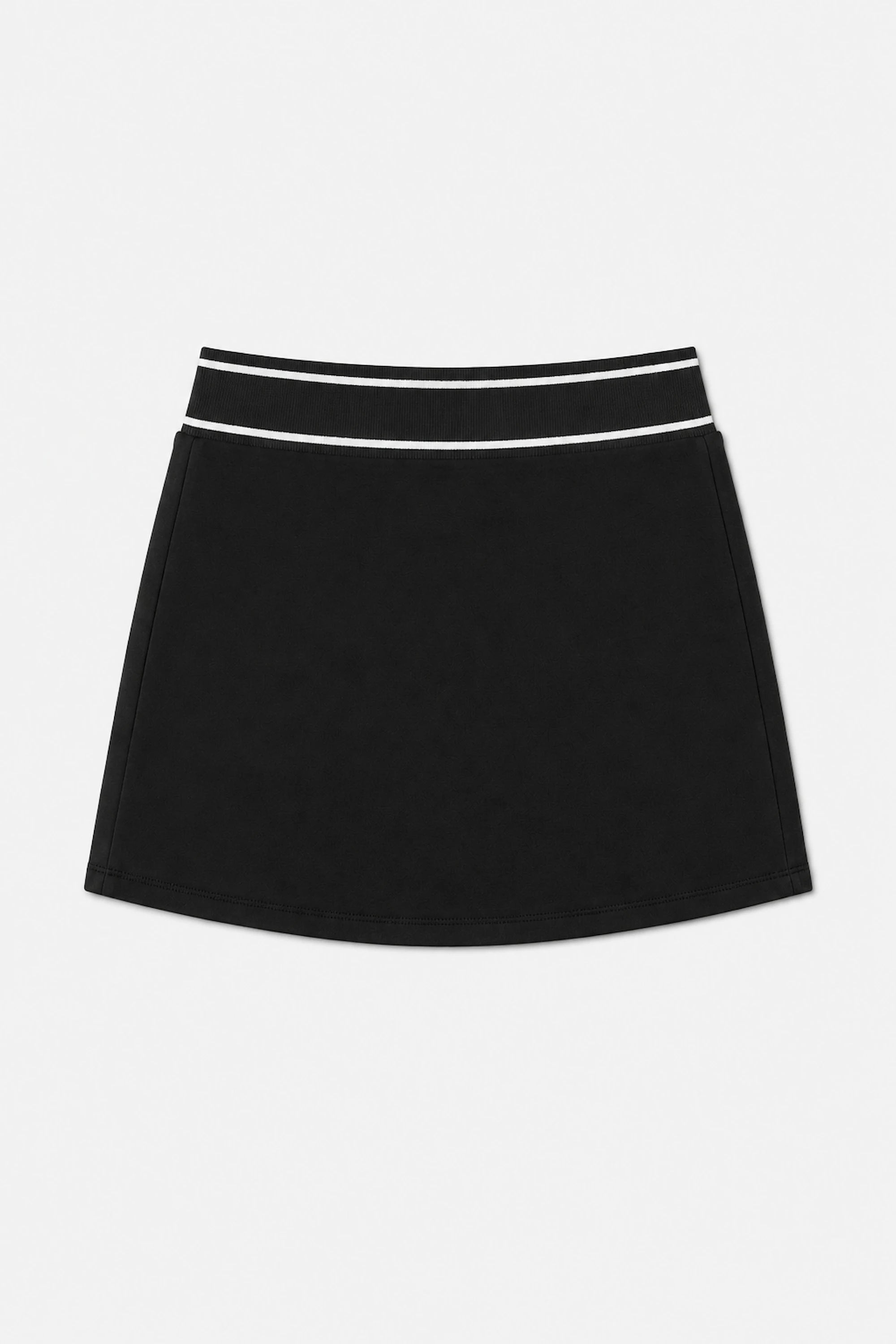Women’s black performance golf skort flat lay with white striped waistband