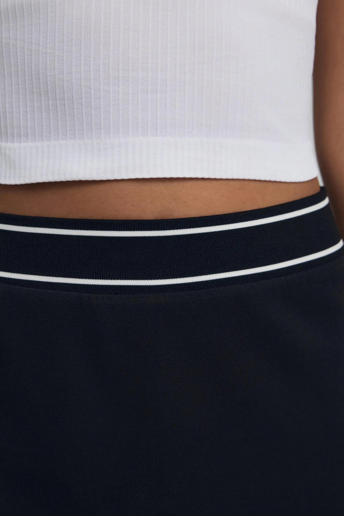 Close-up of black women’s golf skort with white striped elastic waistband