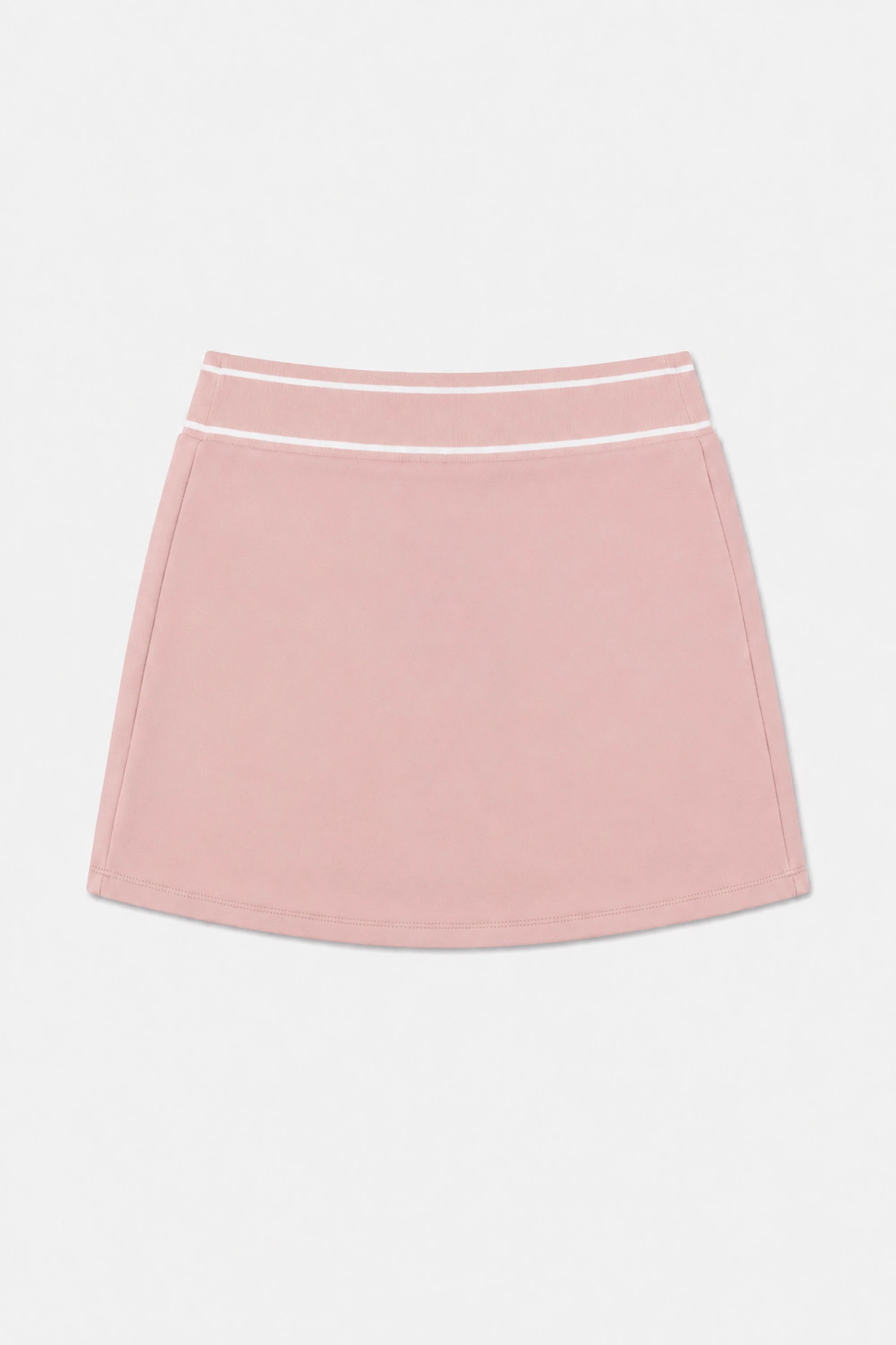 Women’s pink performance golf skort flat lay showing striped waistband and clean front