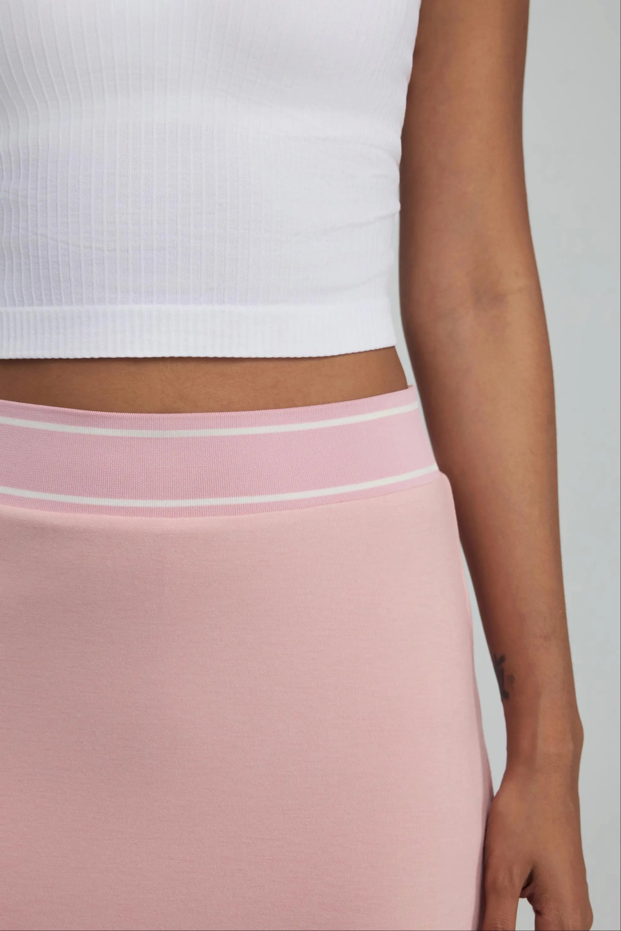 Close-up of pink women’s golf skort with white striped elastic waistband