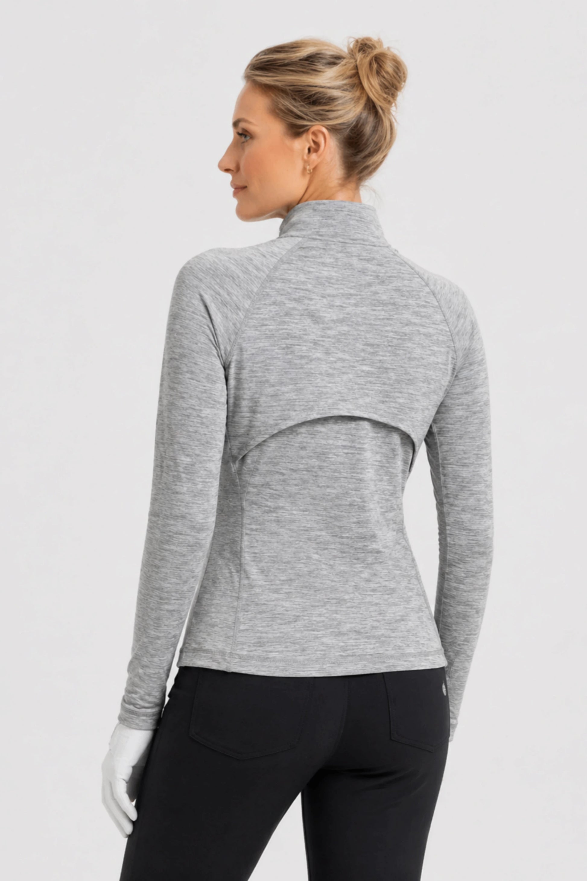 Back view of women’s heather grey golf jacket with breathable vent detail and contoured fit
