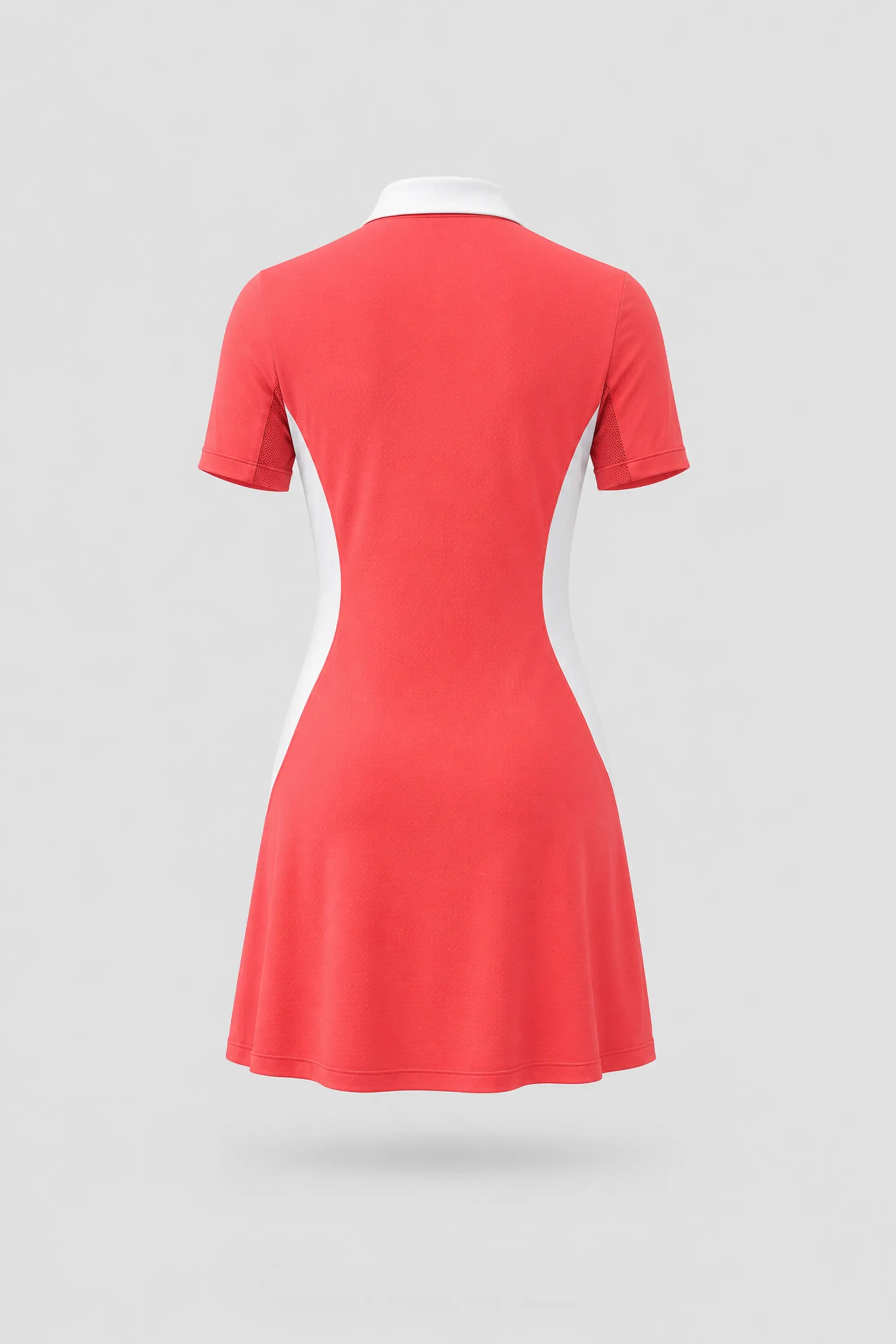 Back view of women's coral red polo golf dress with breathable mesh sleeve panels and athletic fit