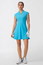 Woman wearing a sky blue cap sleeve zip-front golf dress with contrast piping