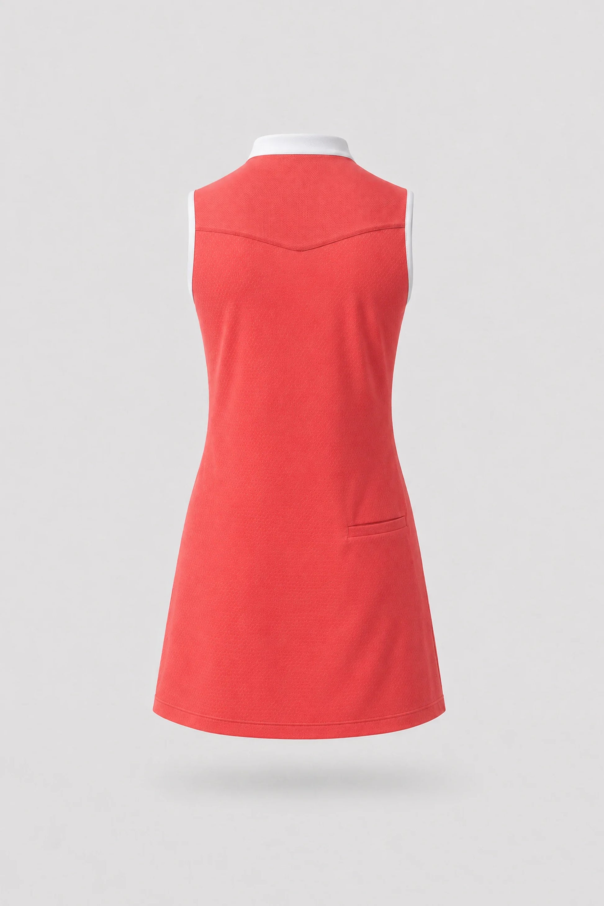 Back view of women's coral red sleeveless golf dress with stretch performance fabric and athletic fit