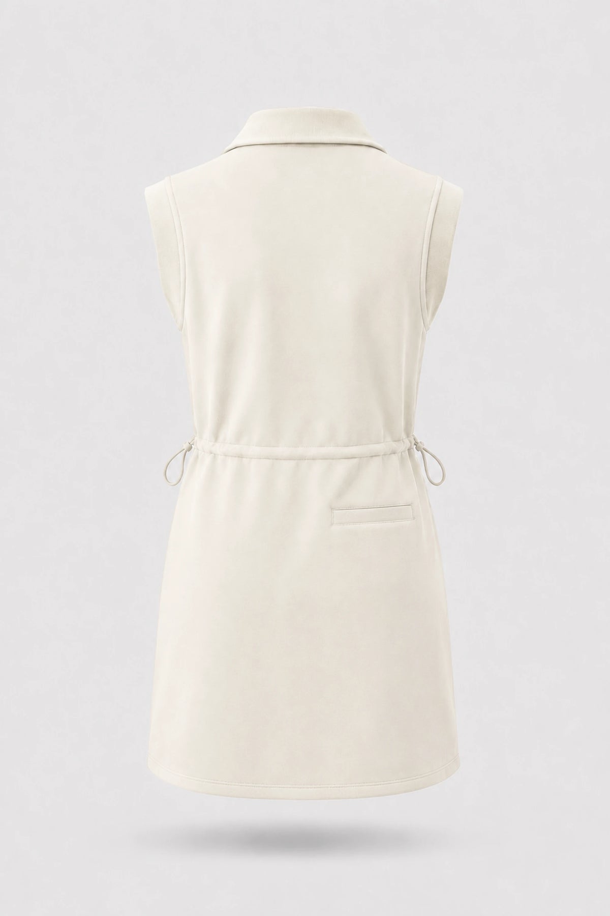 Back view of women's ivory sleeveless golf dress with folded collar, adjustable drawcord waist and back pocket