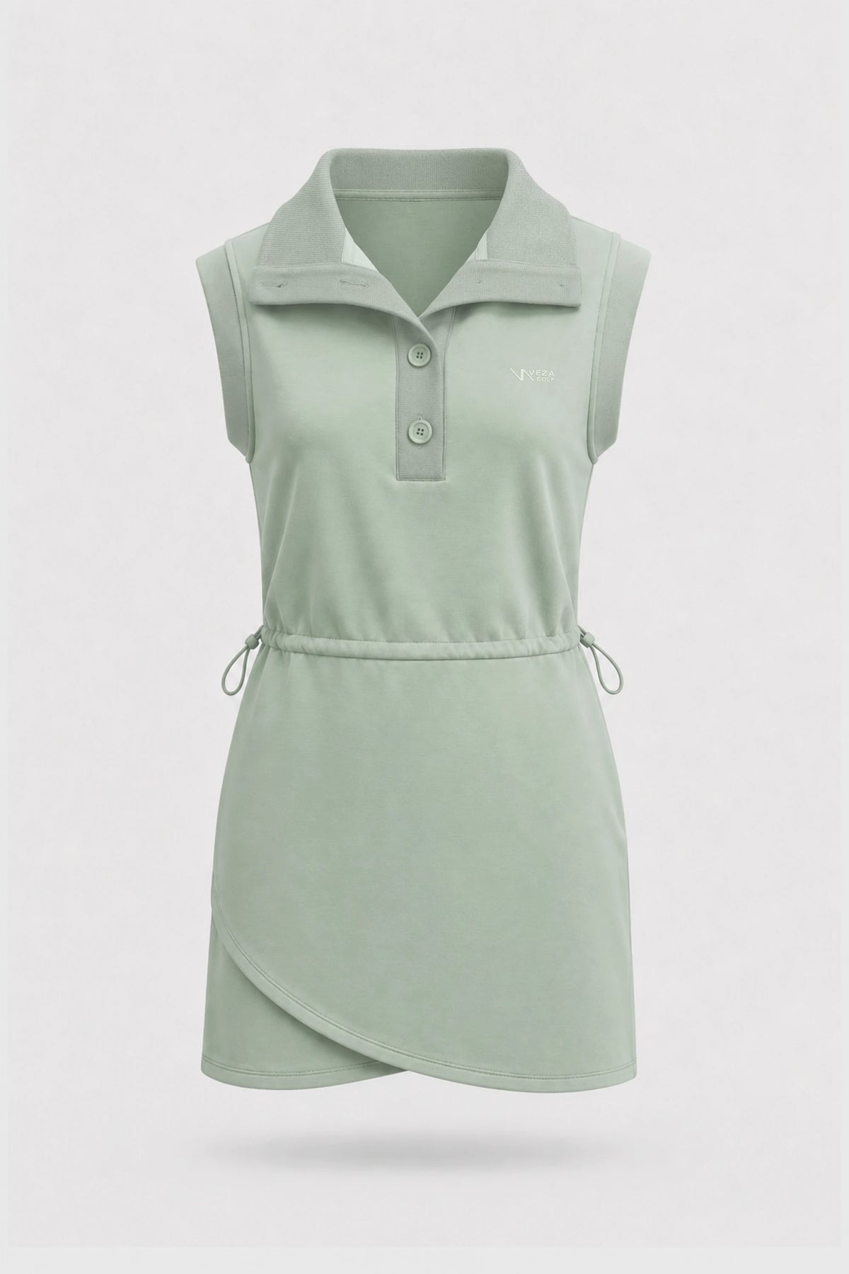 Front view of women's sage green sleeveless golf dress with folded collar, adjustable drawcord waist and asymmetric wrap hem