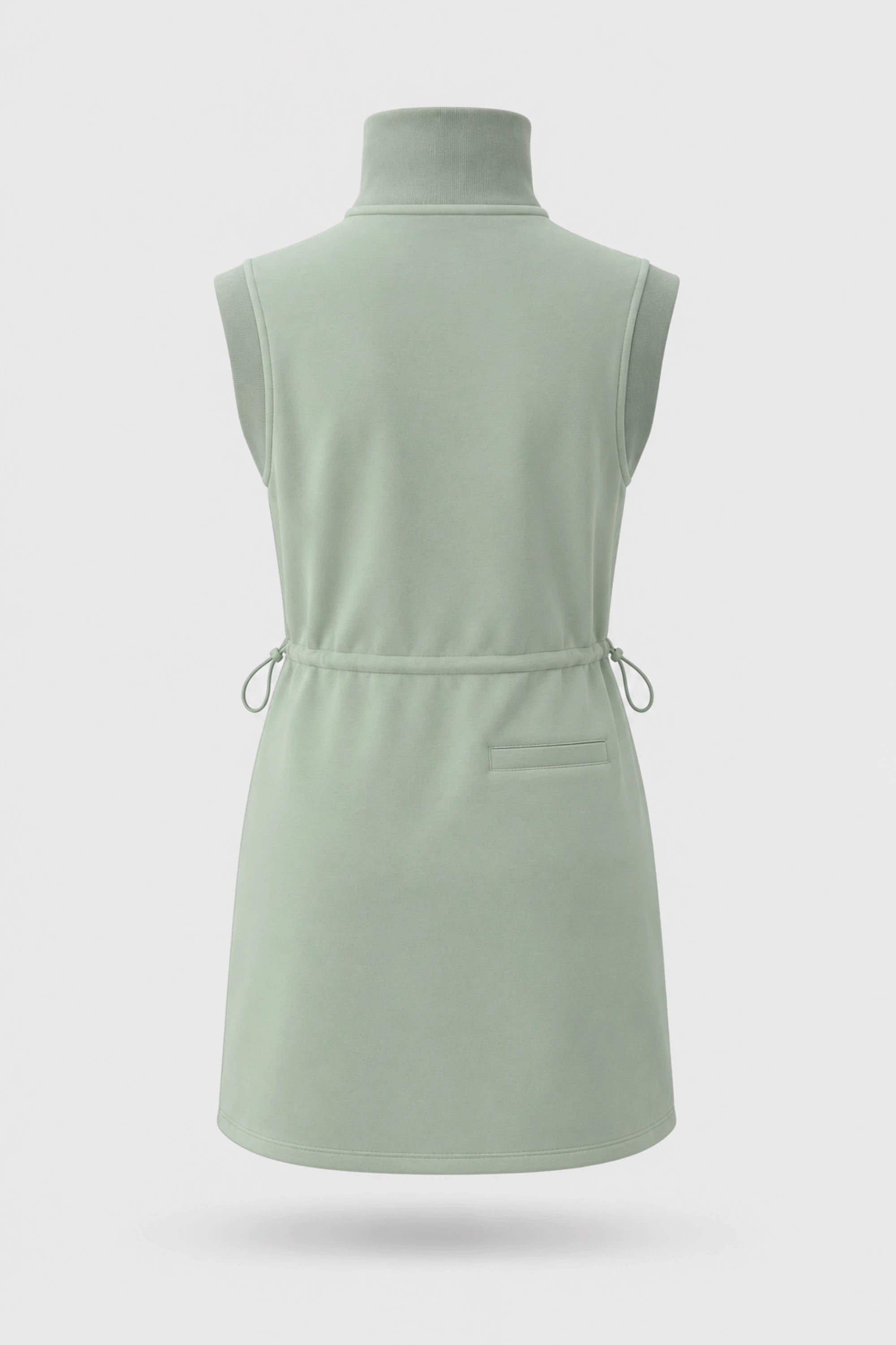 Back view of women's sage green sleeveless golf dress with stand collar, adjustable drawcord waist and back pocket