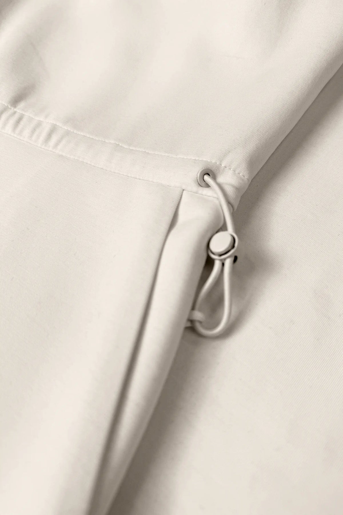 Close-up of the adjustable drawcord waist on the Soft Ivory women’s sleeveless golf dress