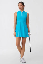 Front view of women’s lagoon blue sleeveless golf dress holding a golf club