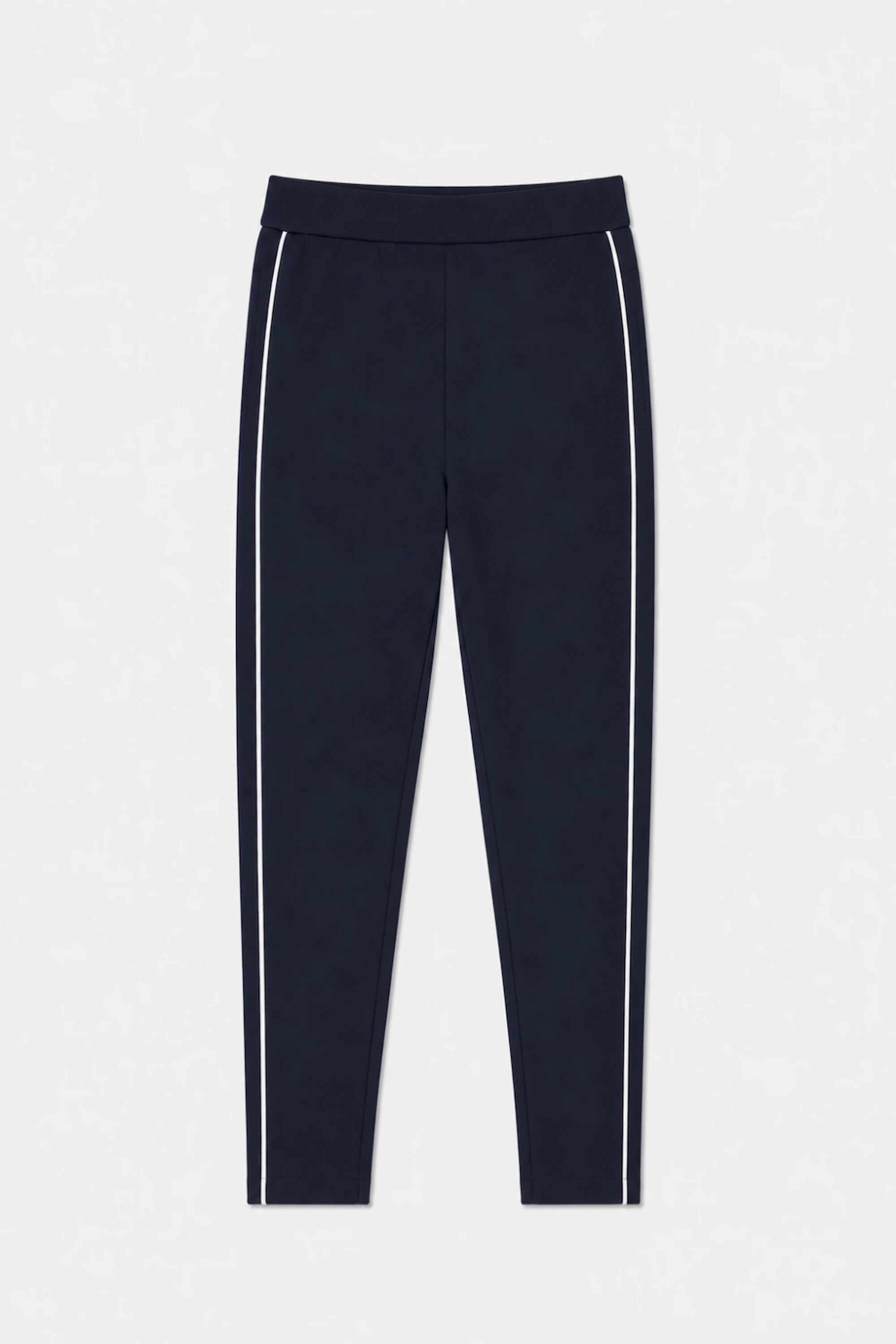 Front flat lay of VEZA women’s Midnight Navy slim fit golf pants featuring contrast white side piping and a streamlined tapered silhouette