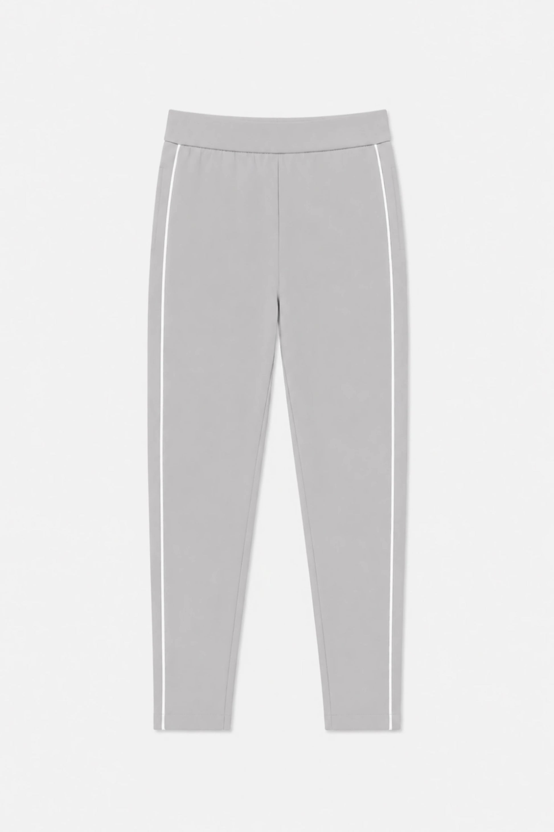 Front flat lay of women’s soft cloud grey slim fit golf pants featuring contrast white side piping and a streamlined tapered silhouette