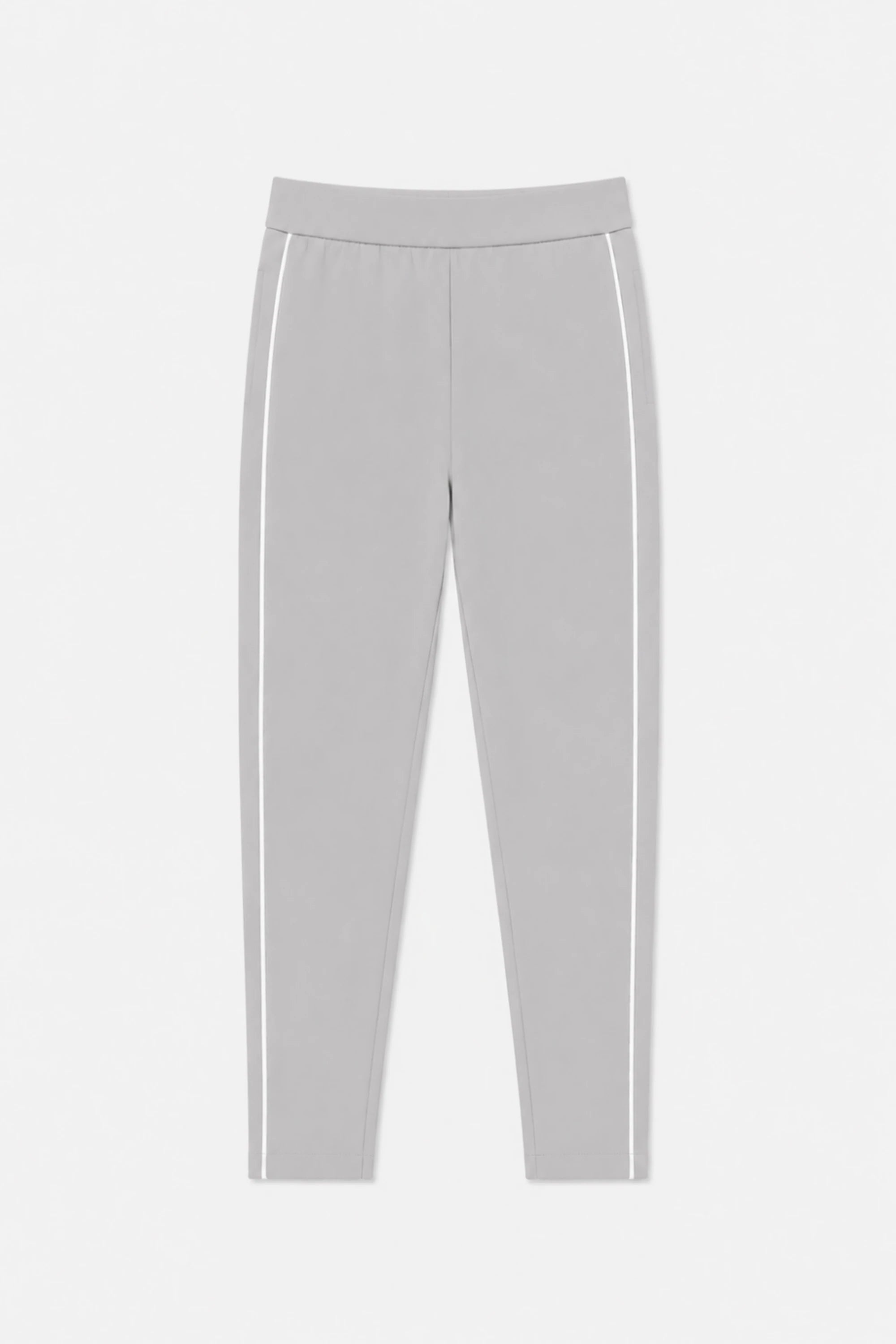 Front flat lay of VEZA women’s Soft Cloud Grey slim fit golf pants featuring contrast white side piping and a streamlined tapered silhouette