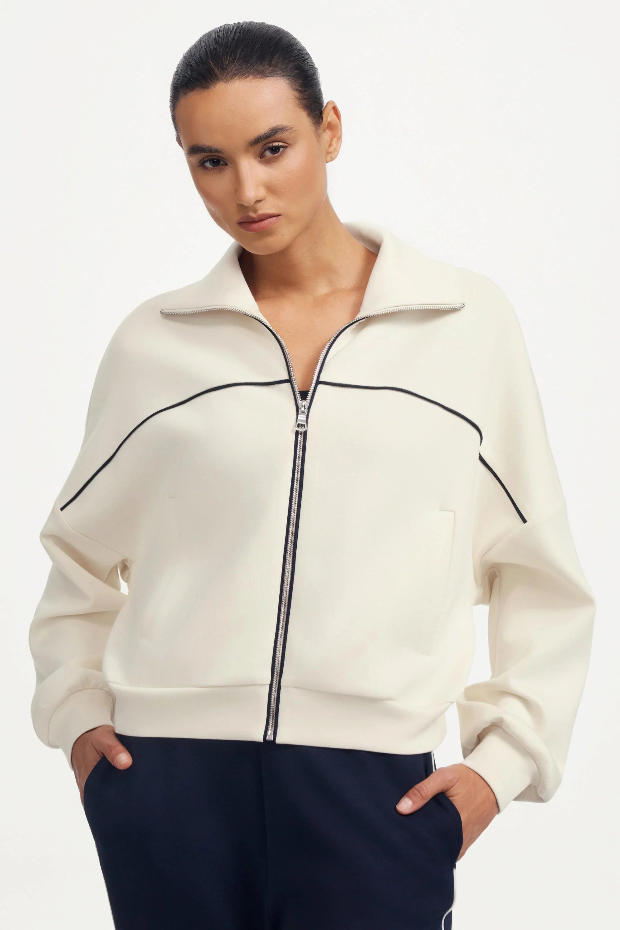 Women’s cropped golf jacket in soft ivory white with contrast piping and a zip-front collar