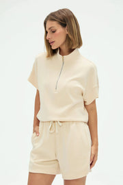 Women’s soft oatmilk performance quarter-zip top featuring a clean collar and lightweight stretch fabric