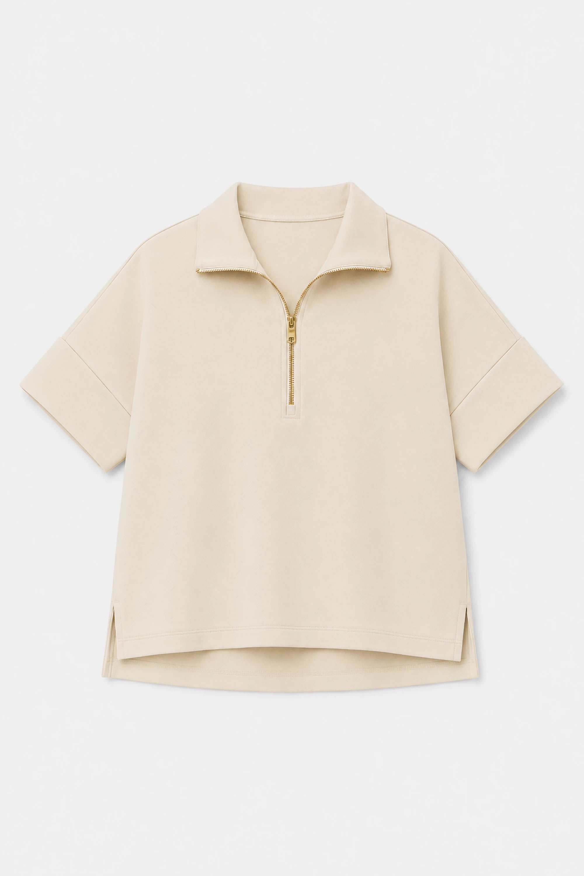 Women’s soft oatmilk performance quarter-zip top shown in flat lay view with minimalist design details