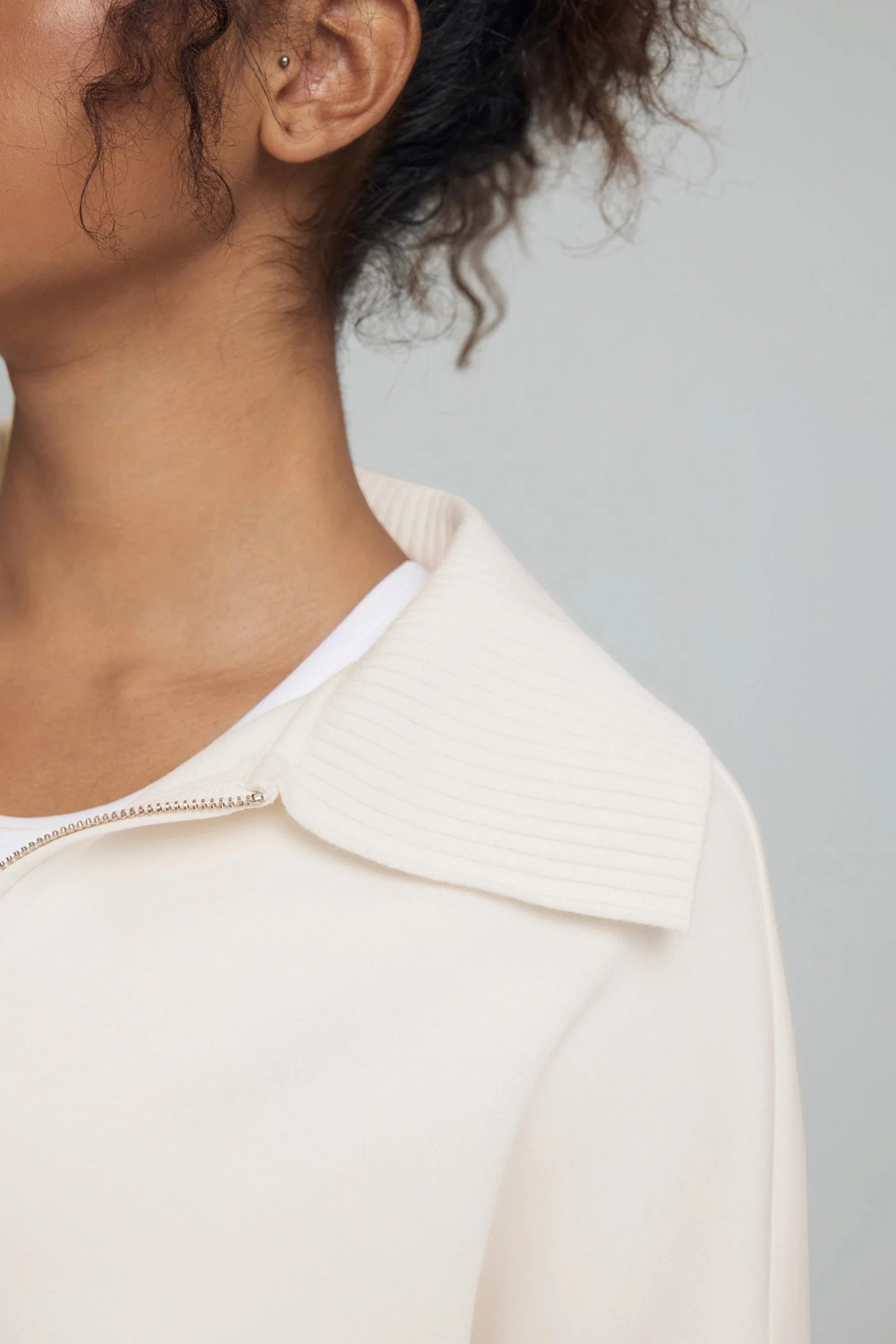 Close-up detail of the ribbed collar on women’s soft sand cropped knit zip jacket