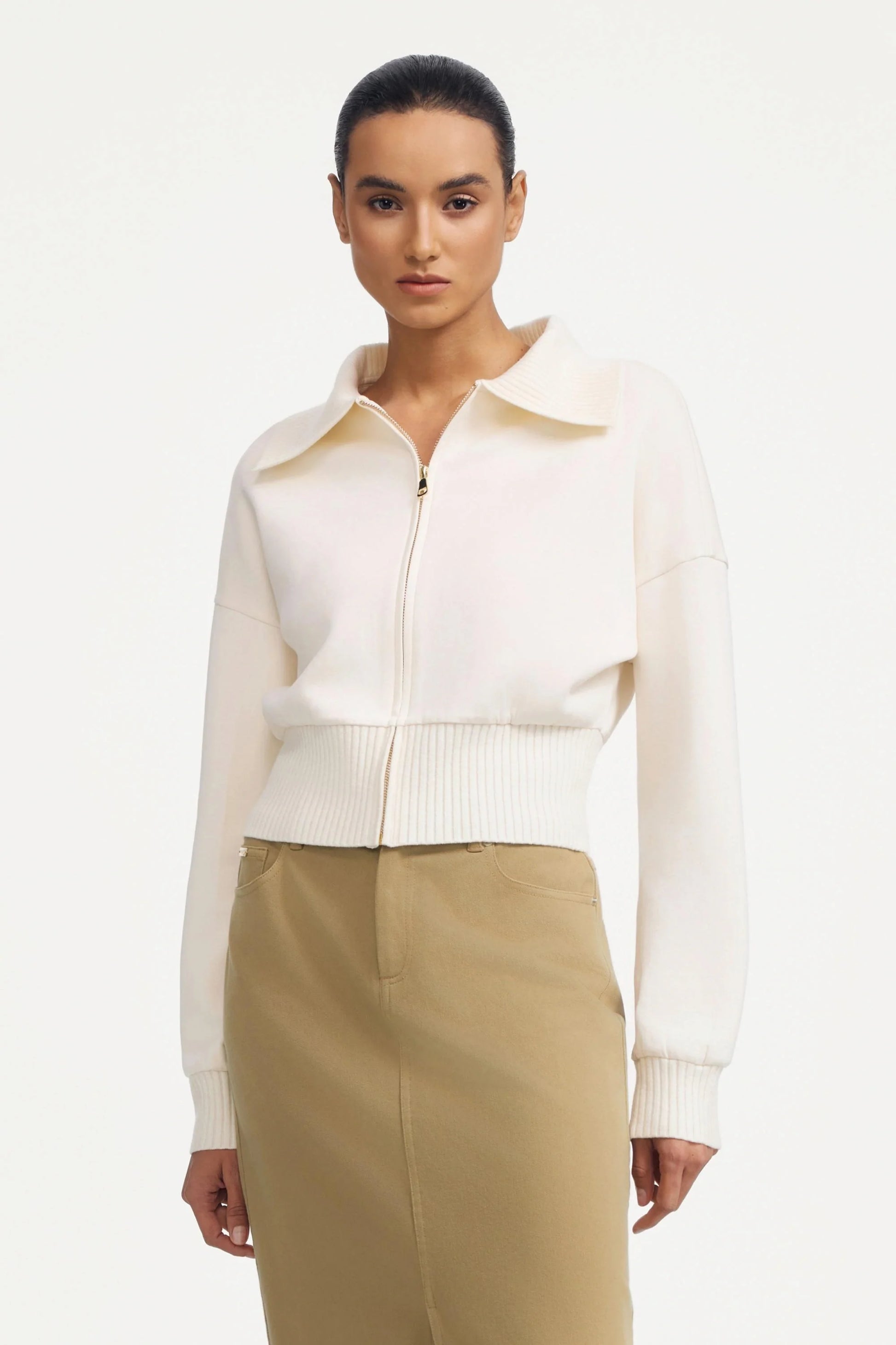 Women’s soft sand cropped knit zip jacket styled with a beige maxi skirt