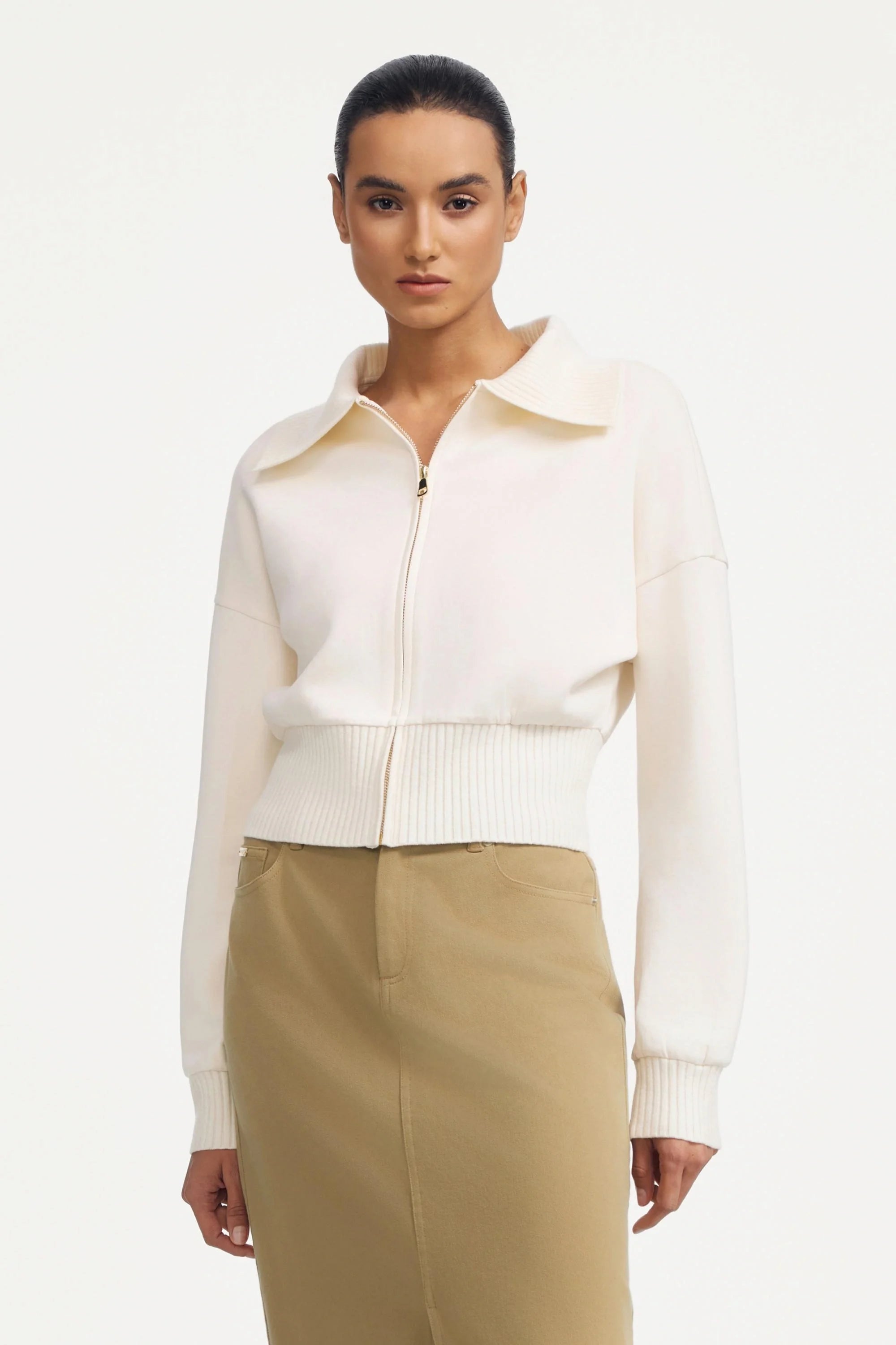 Women’s soft sand cropped knit zip jacket styled with a beige maxi skirt