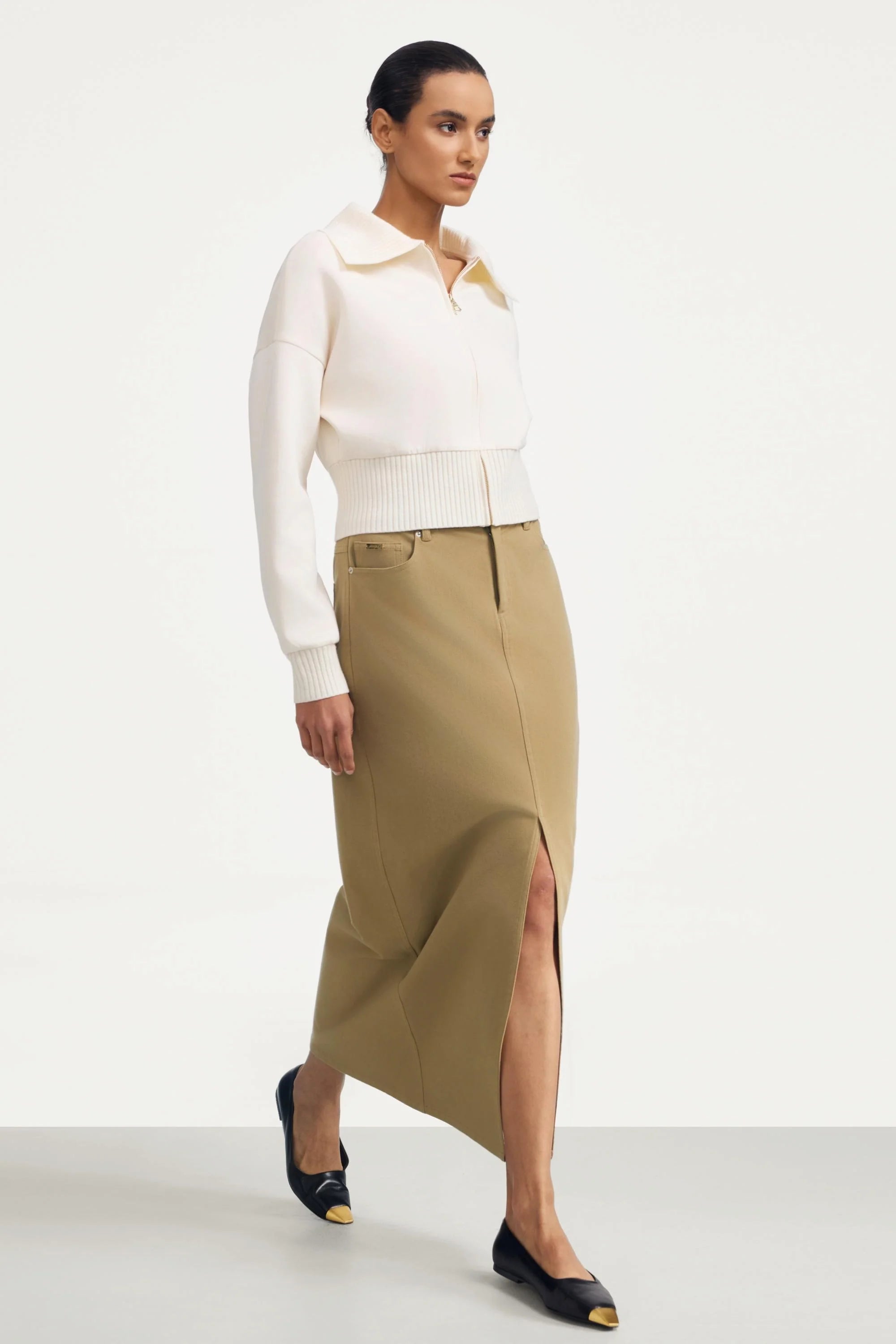 Women’s soft sand cropped knit zip jacket paired with a beige slit maxi skirt