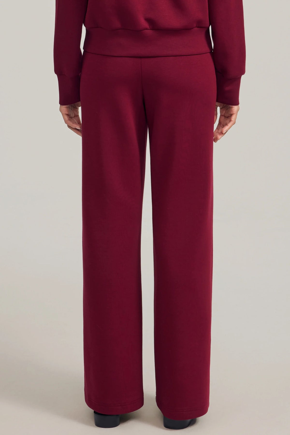 Back view of women's Burgundy Wine straight-leg pants showing the waistband and full-length cut