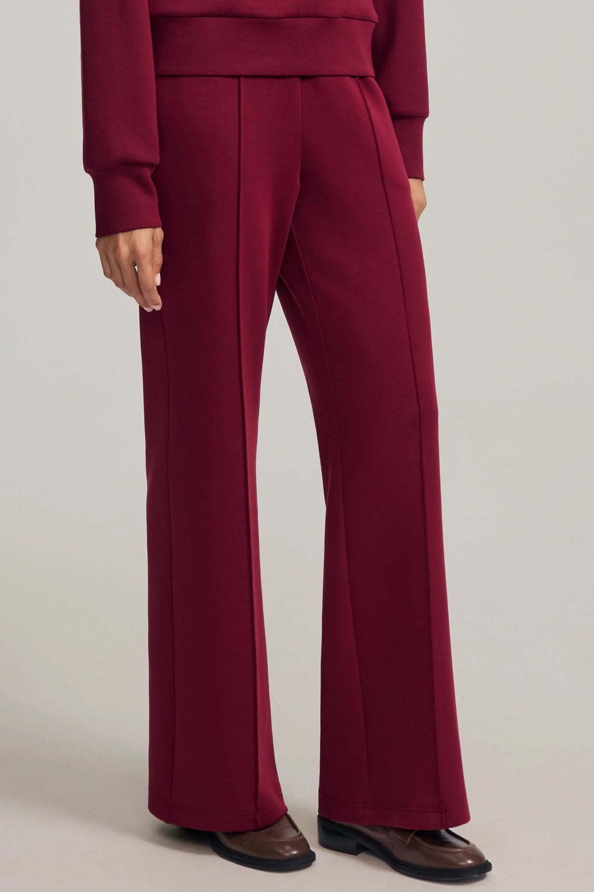 Women's Burgundy Wine straight-leg pants with defined front seams and a relaxed full-length silhouette
