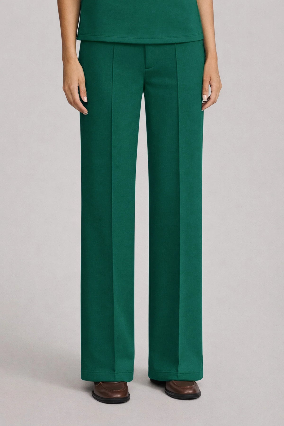 Front view of women's dark green straight-leg pants with defined front seams and a relaxed full-length silhouette