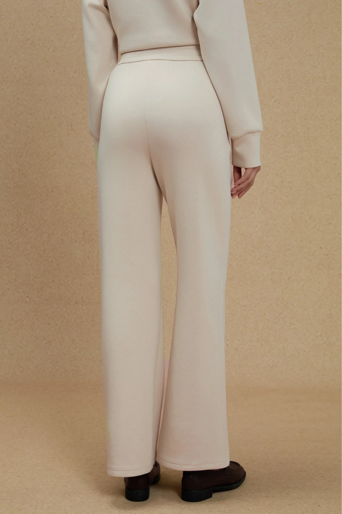 Back view of women's Oatmilk straight-leg pants showing the clean waistband and relaxed full-length silhouette
