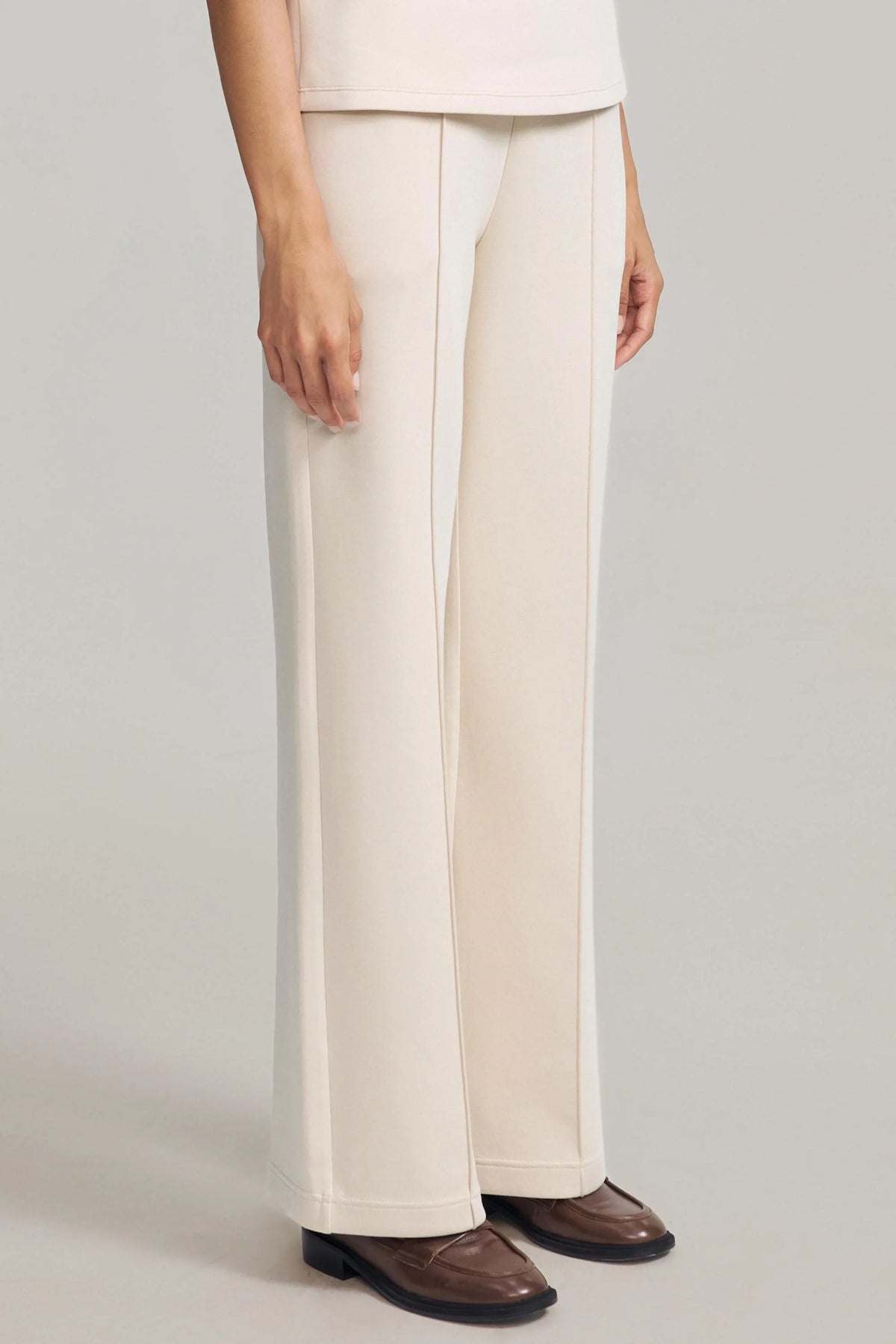 Three-quarter view of women's Oatmilk straight-leg pants showing the relaxed fit and full-length design