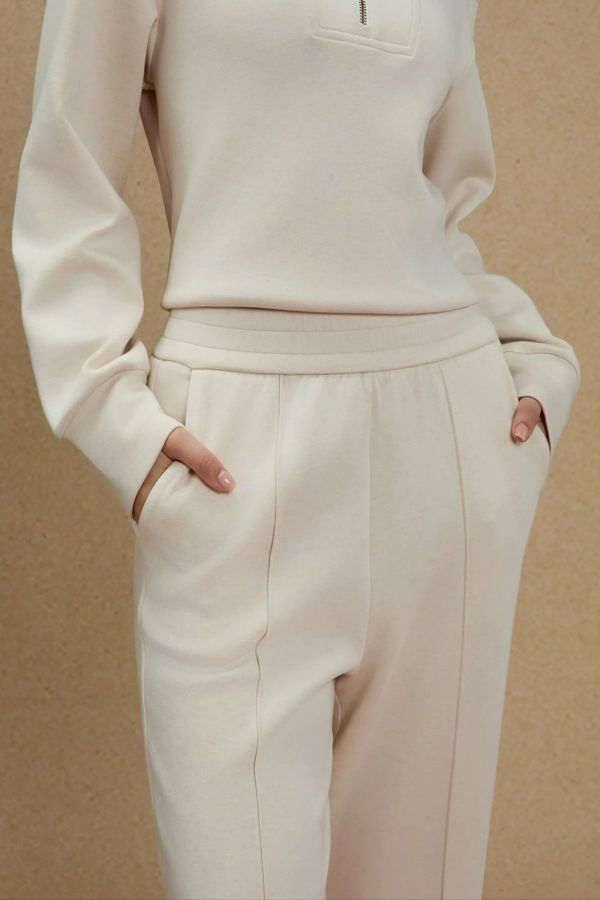 Close-up of women's Oatmilk straight-leg pants showing the waistband, side pockets and front seam details