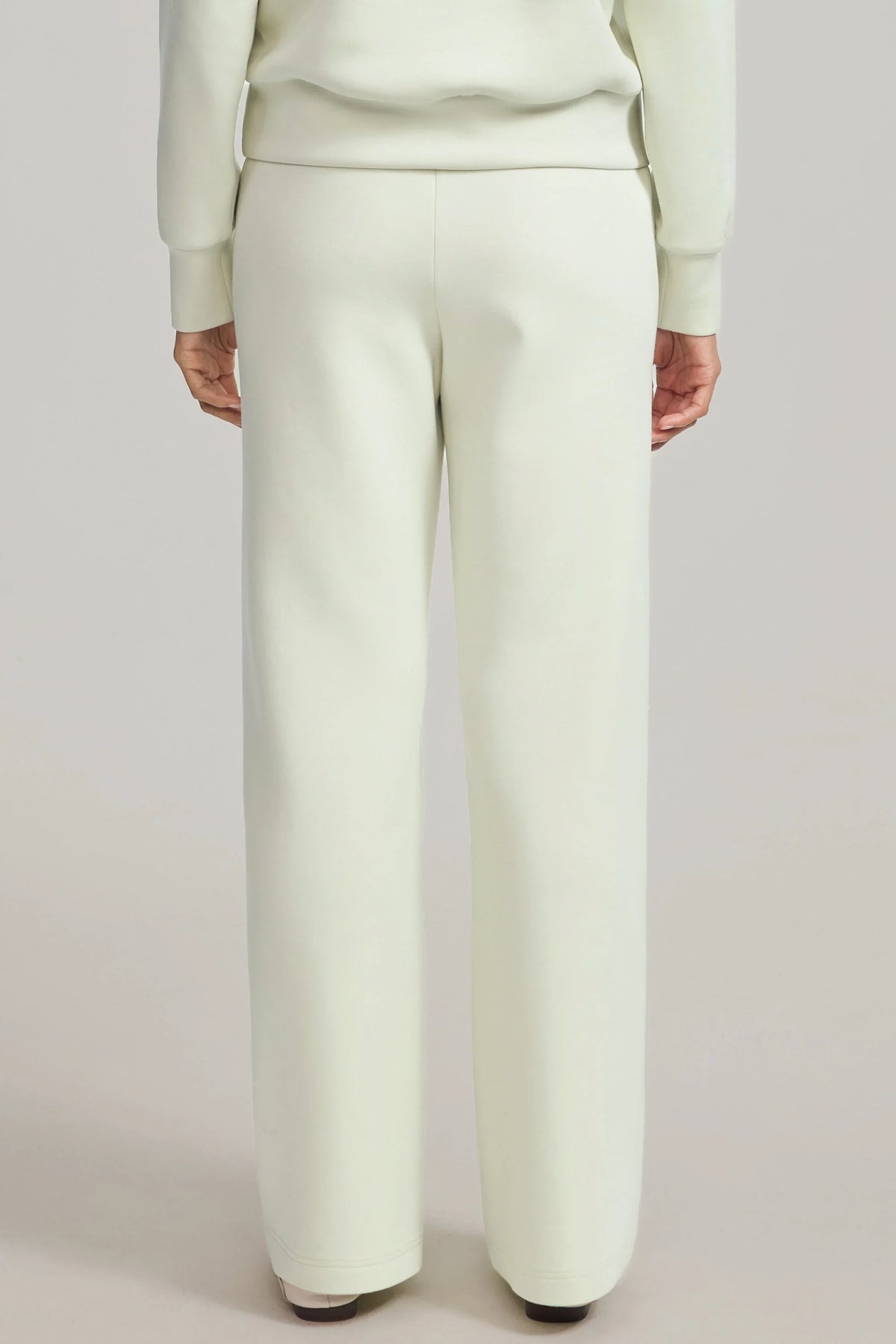 Back view of women's Pistachio Cream straight-leg pants showing the waistband and full-length cut