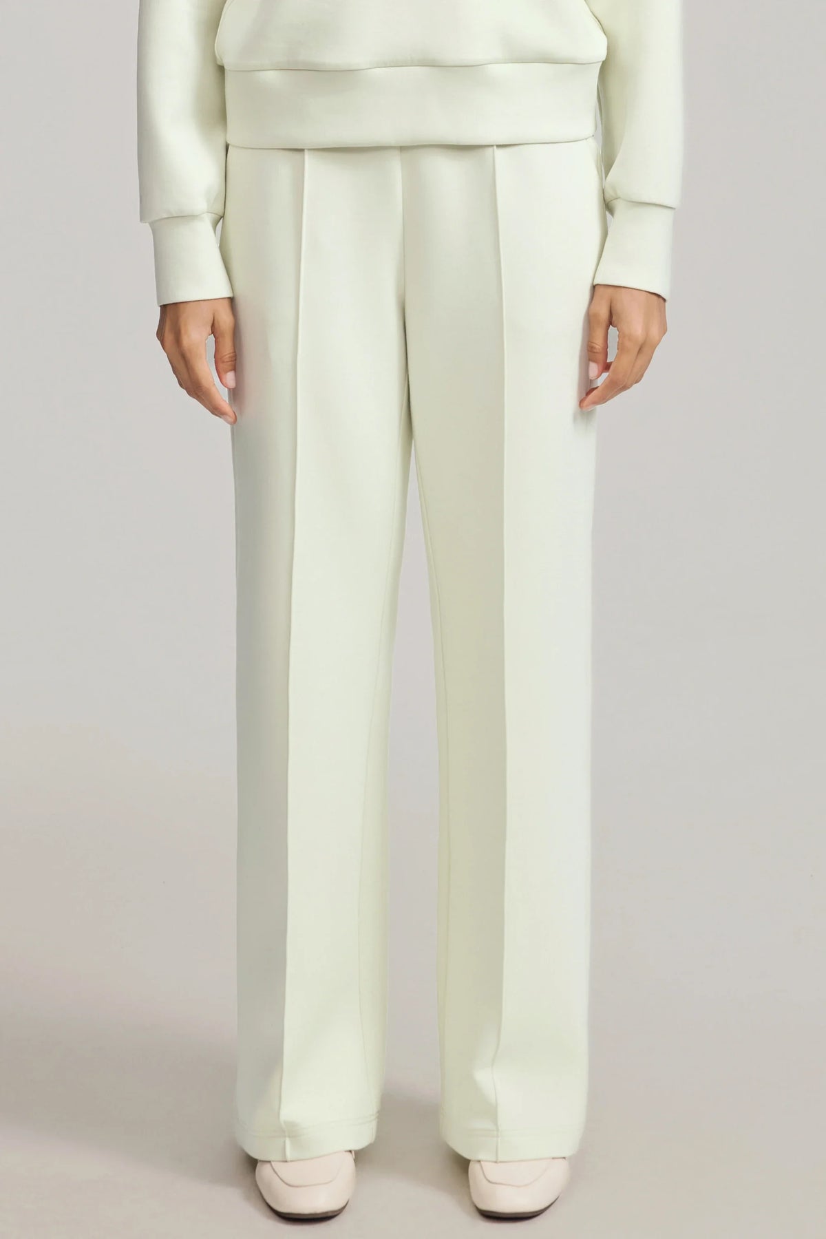 Women's straight-leg pants in Pistachio Cream with defined front seams and a relaxed full-length silhouette