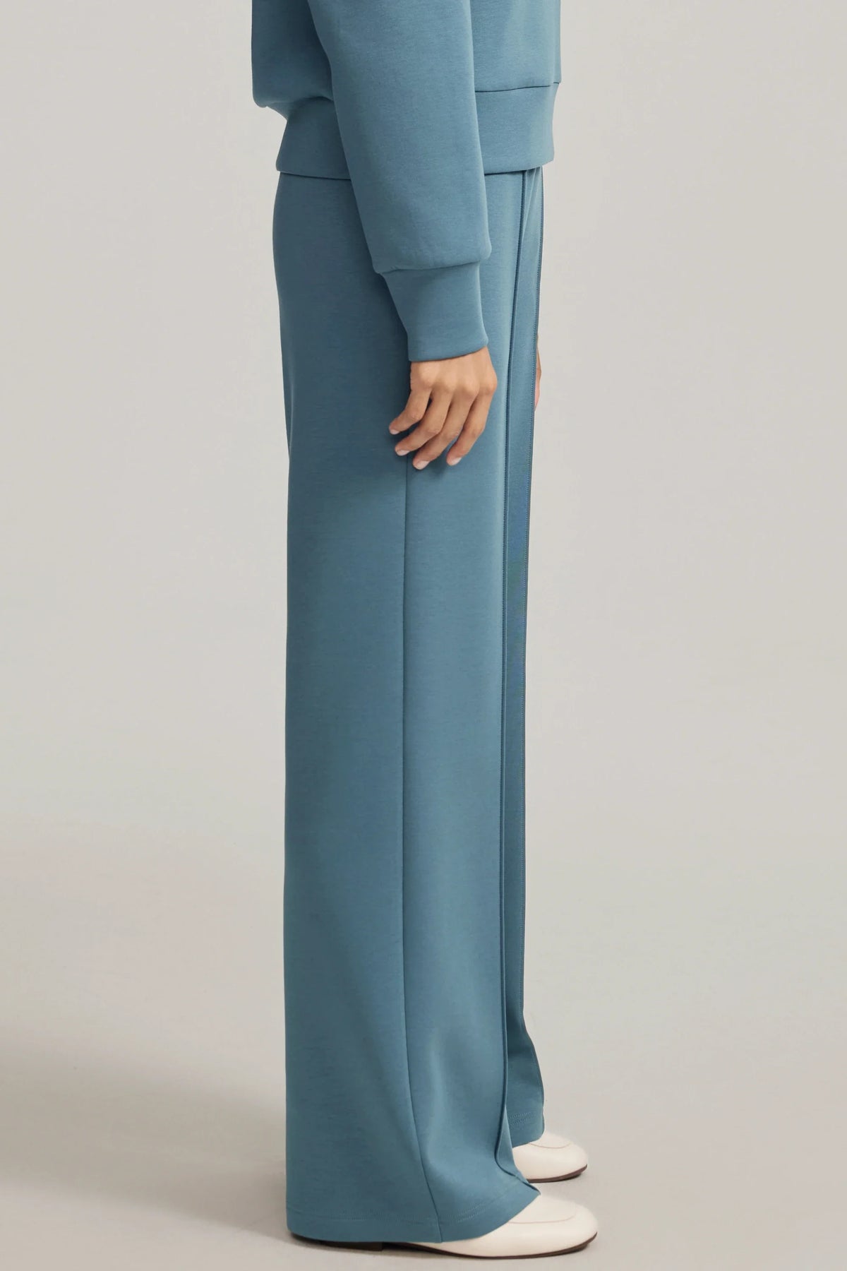 Side view of women's Slate Blue straight-leg pants showing the fluid drape and full-length cut