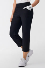 Angled front view of women’s tailored capri golf pants in onyx black with a smooth pull-on waistband