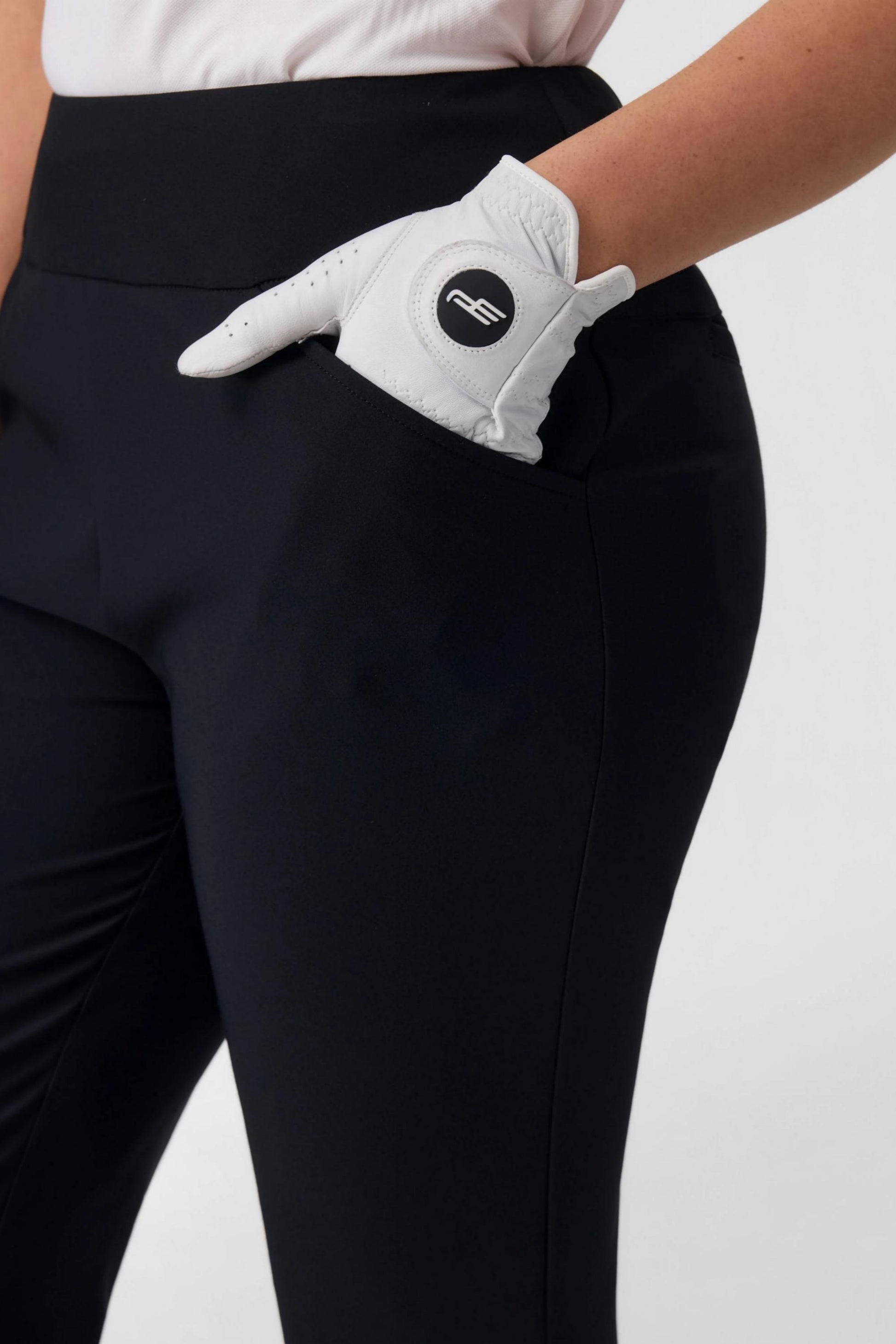 Detail of side pocket on women’s onyx black tailored capri golf pants with performance stretch fabric