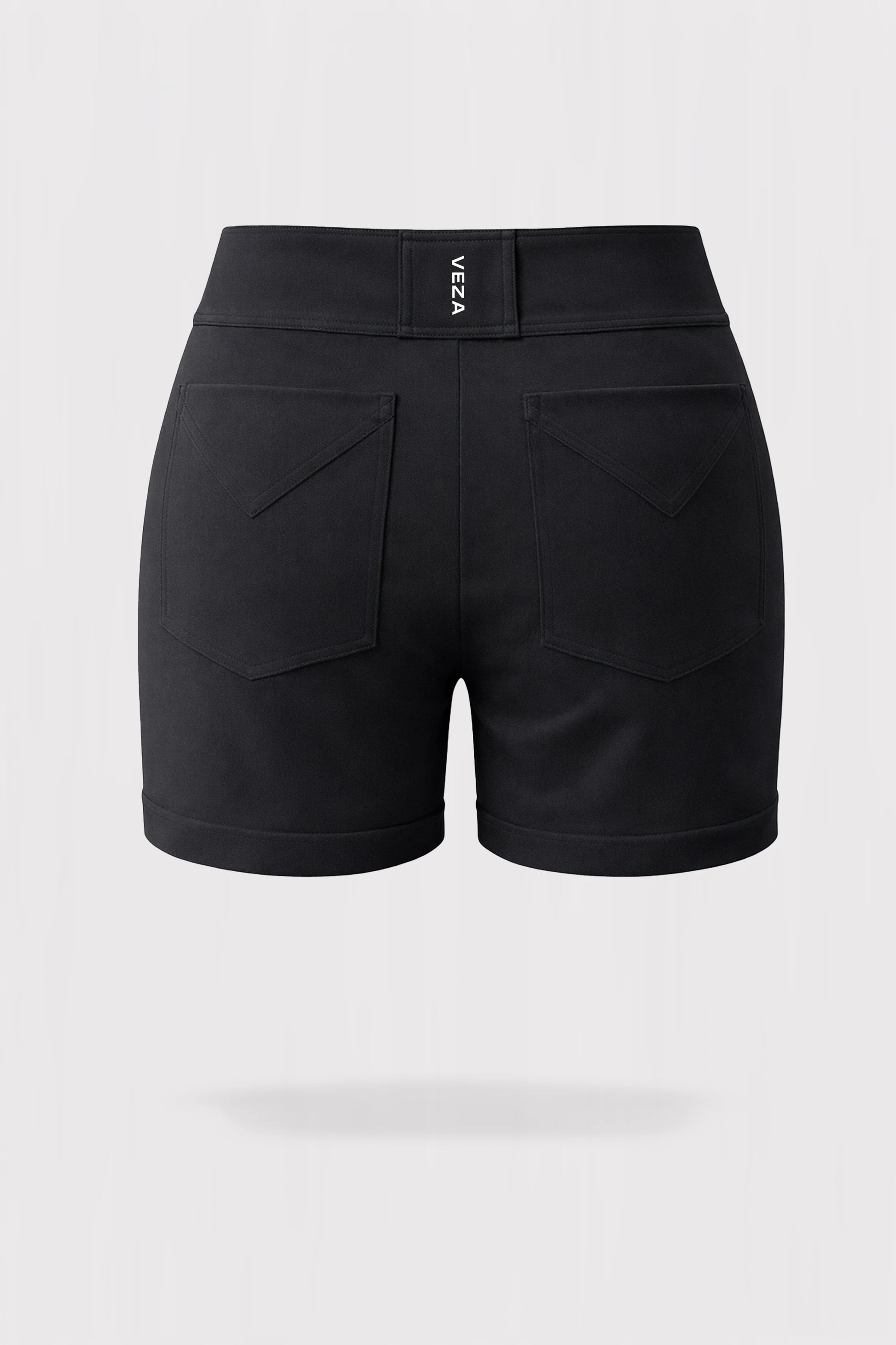 Back 3D render of women’s tailored utility bermuda golf shorts in black featuring back patch pockets and VEZA branding at the waistband