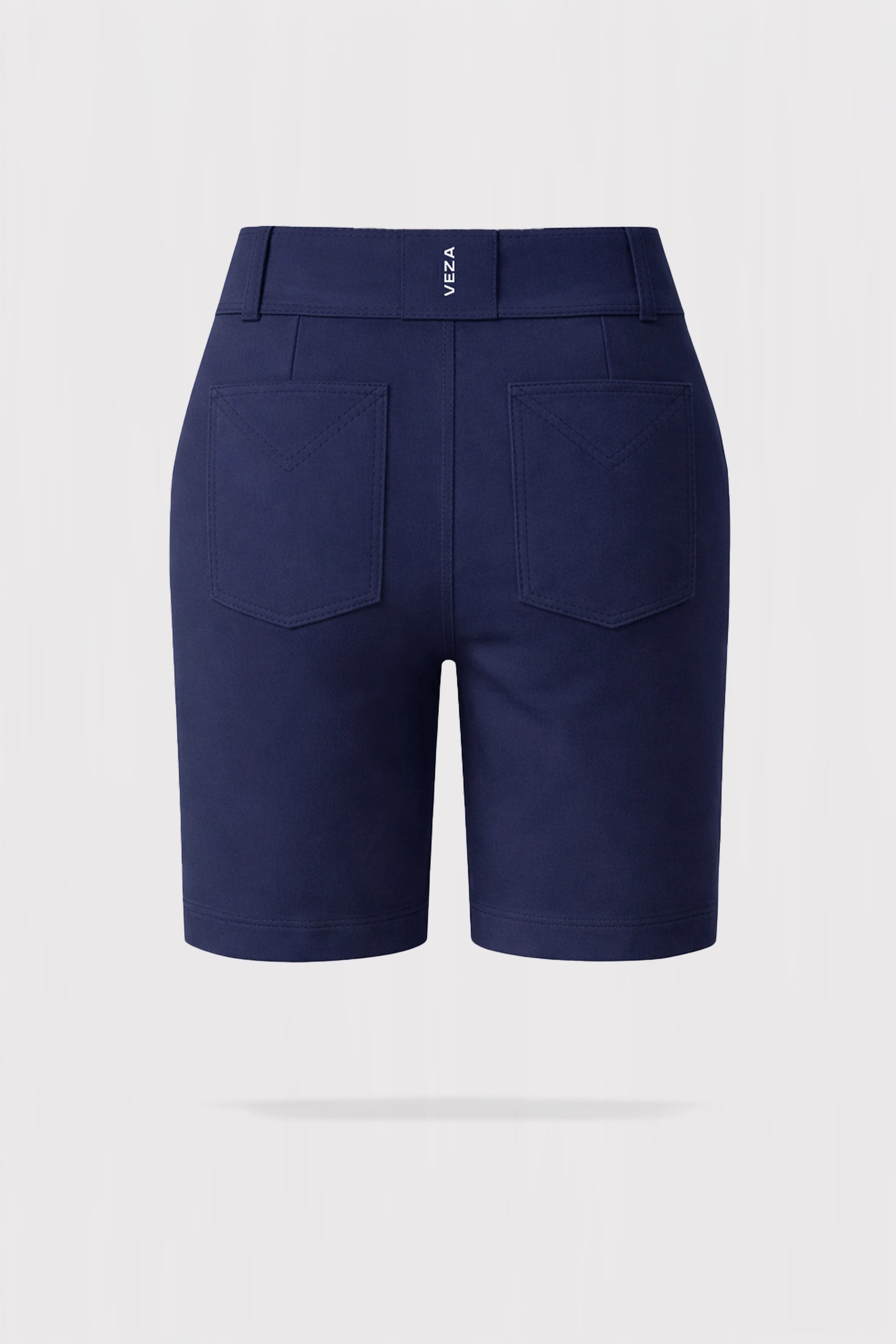 Back 3D render of women’s tailored utility bermuda golf shorts in navy featuring back patch pockets and VEZA branding at the waistband