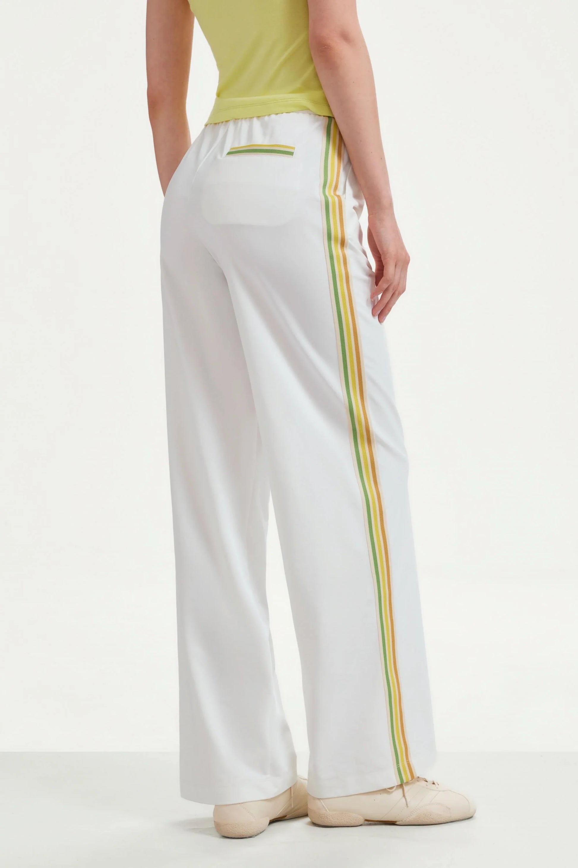 Back view of women’s classic white wide-leg pants with side stripes and back welt pocket