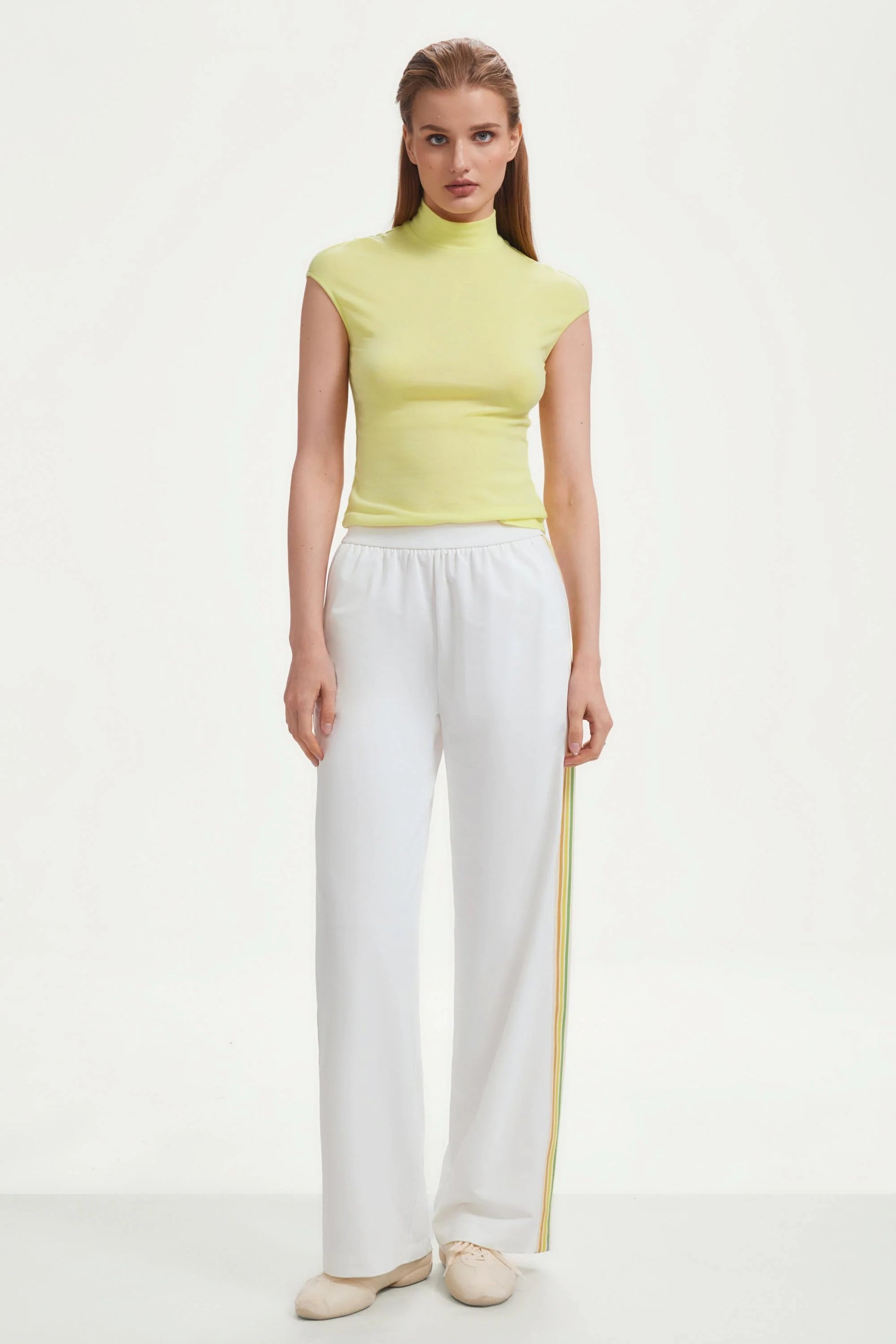 Front view of women’s classic white wide-leg pants with side stripes