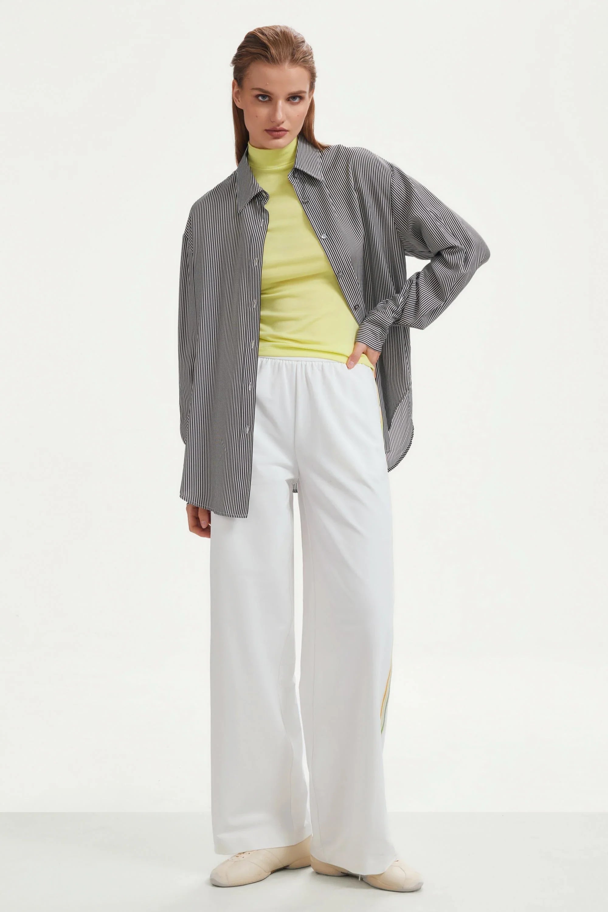 Women’s classic white wide-leg pants with side stripes styled in a layered outfit