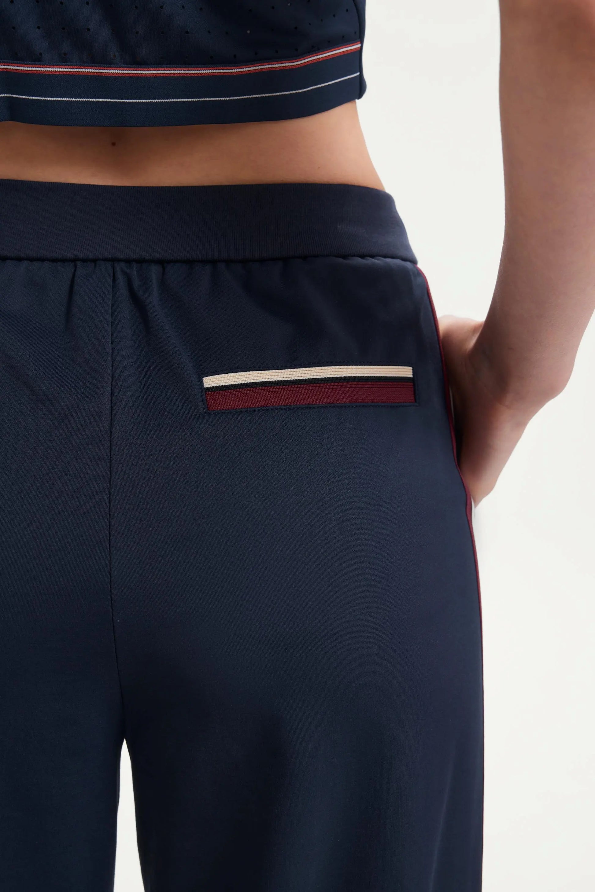 Back pocket detail of women’s midnight navy wide-leg pants with contrast stripe trim