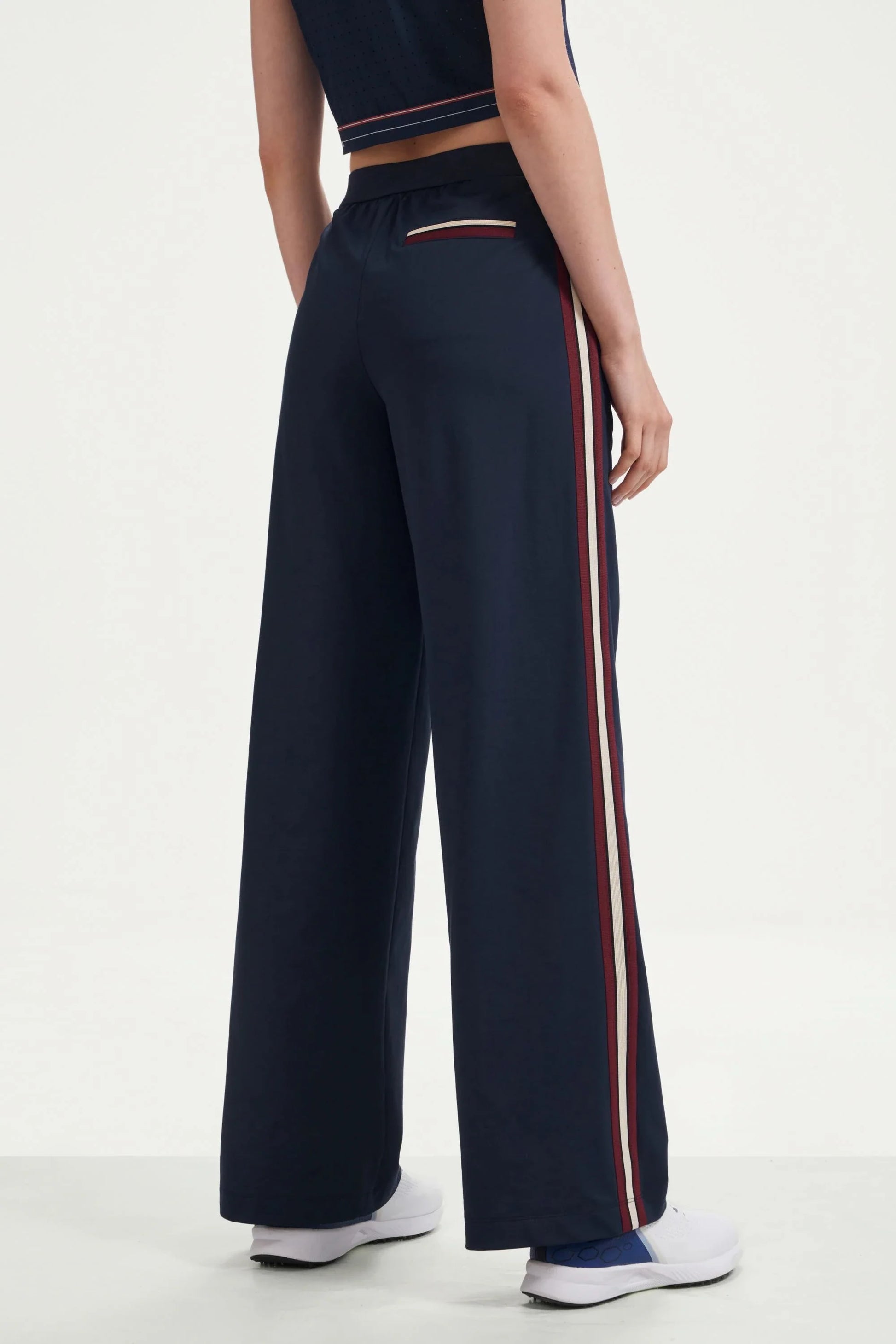 Back view of women’s midnight navy wide-leg pants with side stripes and back welt pocket