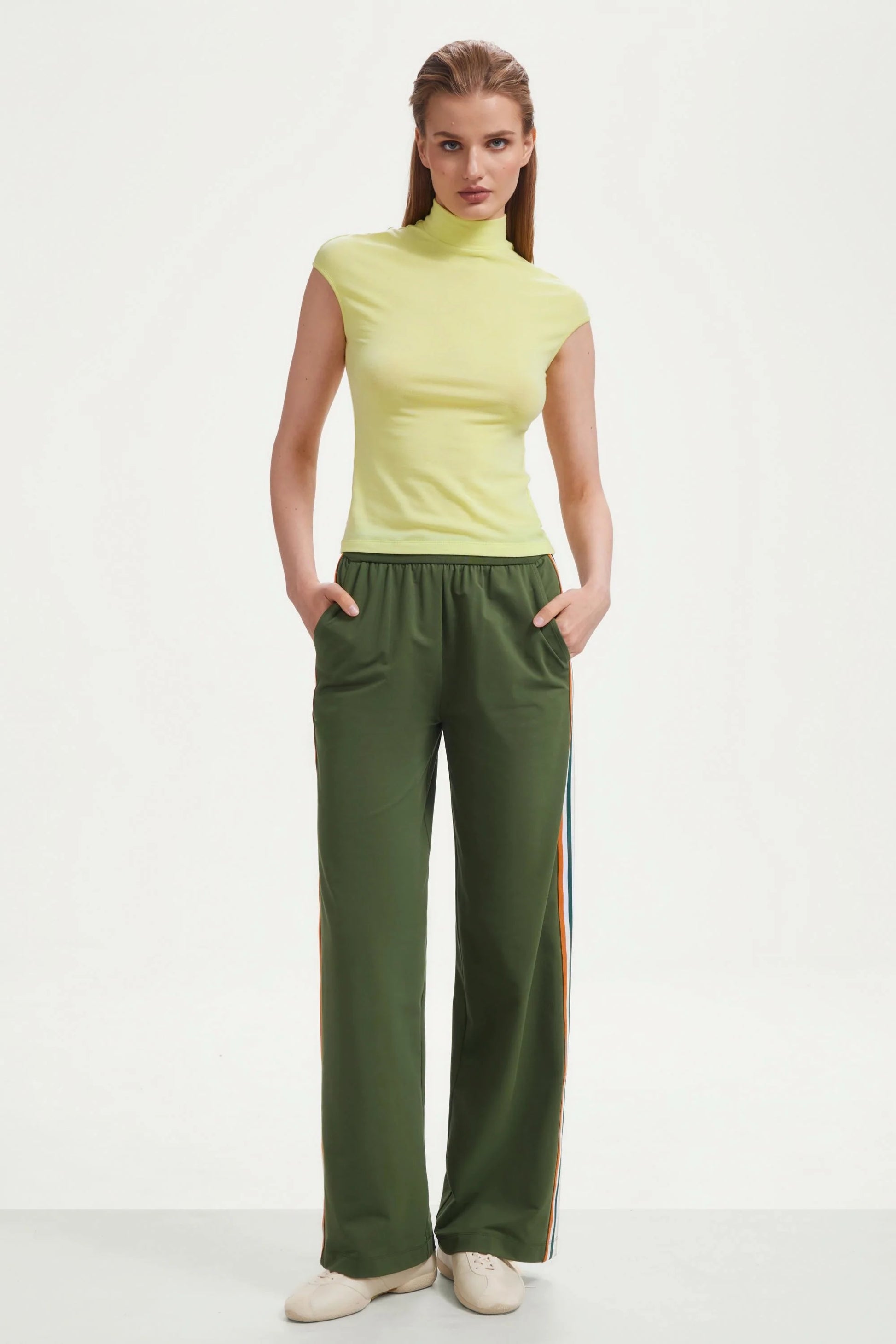 Full look of women’s olive green wide-leg pants with side stripes