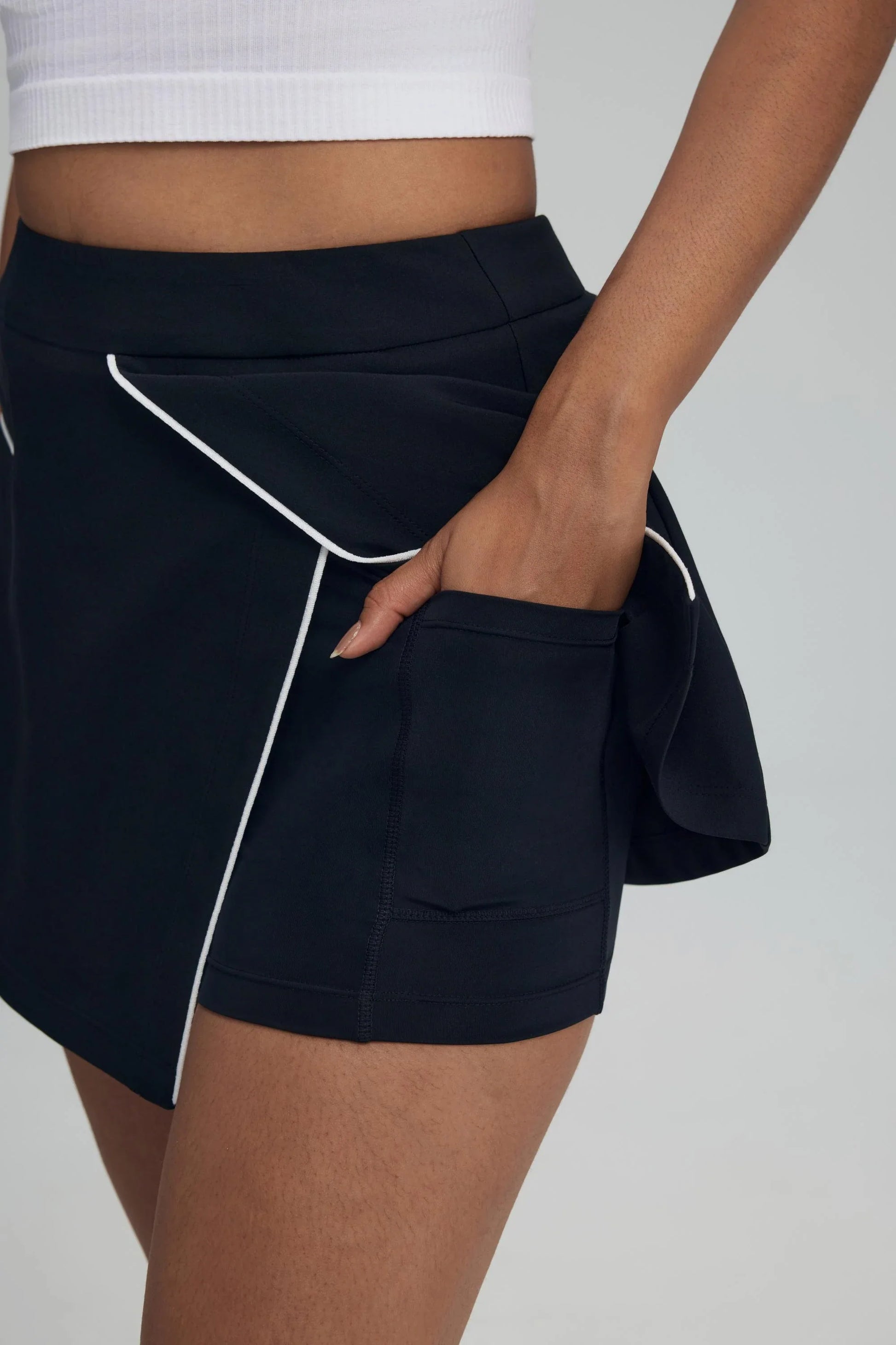 Built-in shorts with pocket detail inside women’s jet black wrap front golf skort