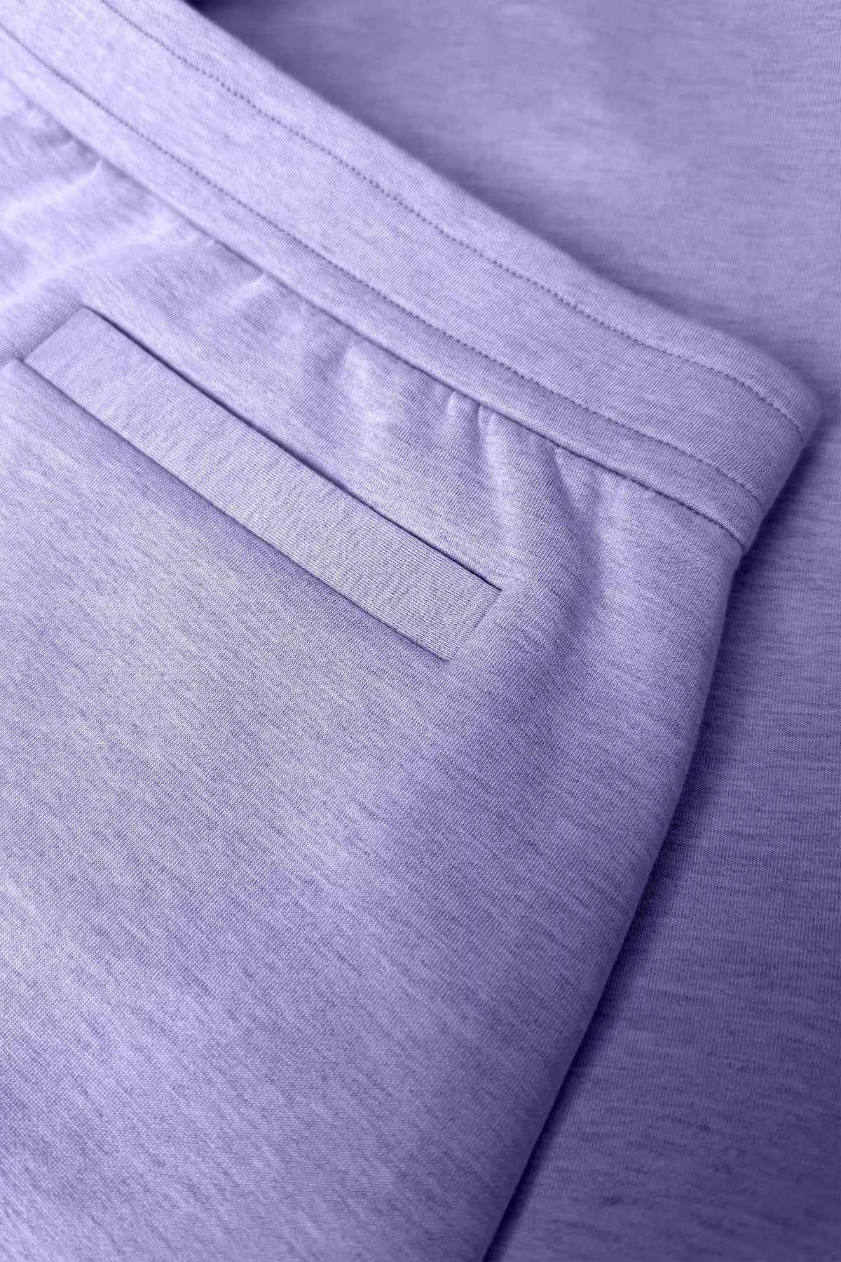 Close-up of women’s lavender wrap golf skort with waistband and welt back pocket detail