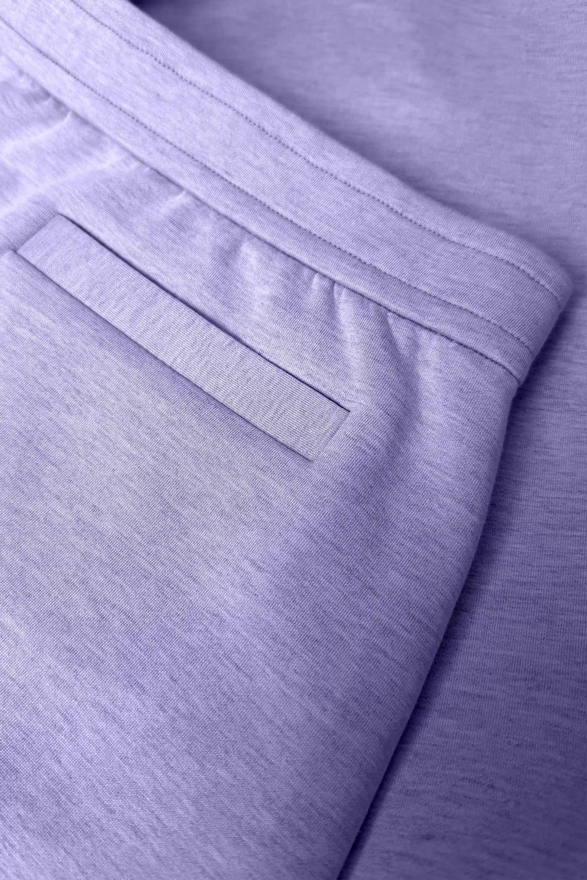 Close-up of women’s lavender wrap golf skort with waistband and welt back pocket detail