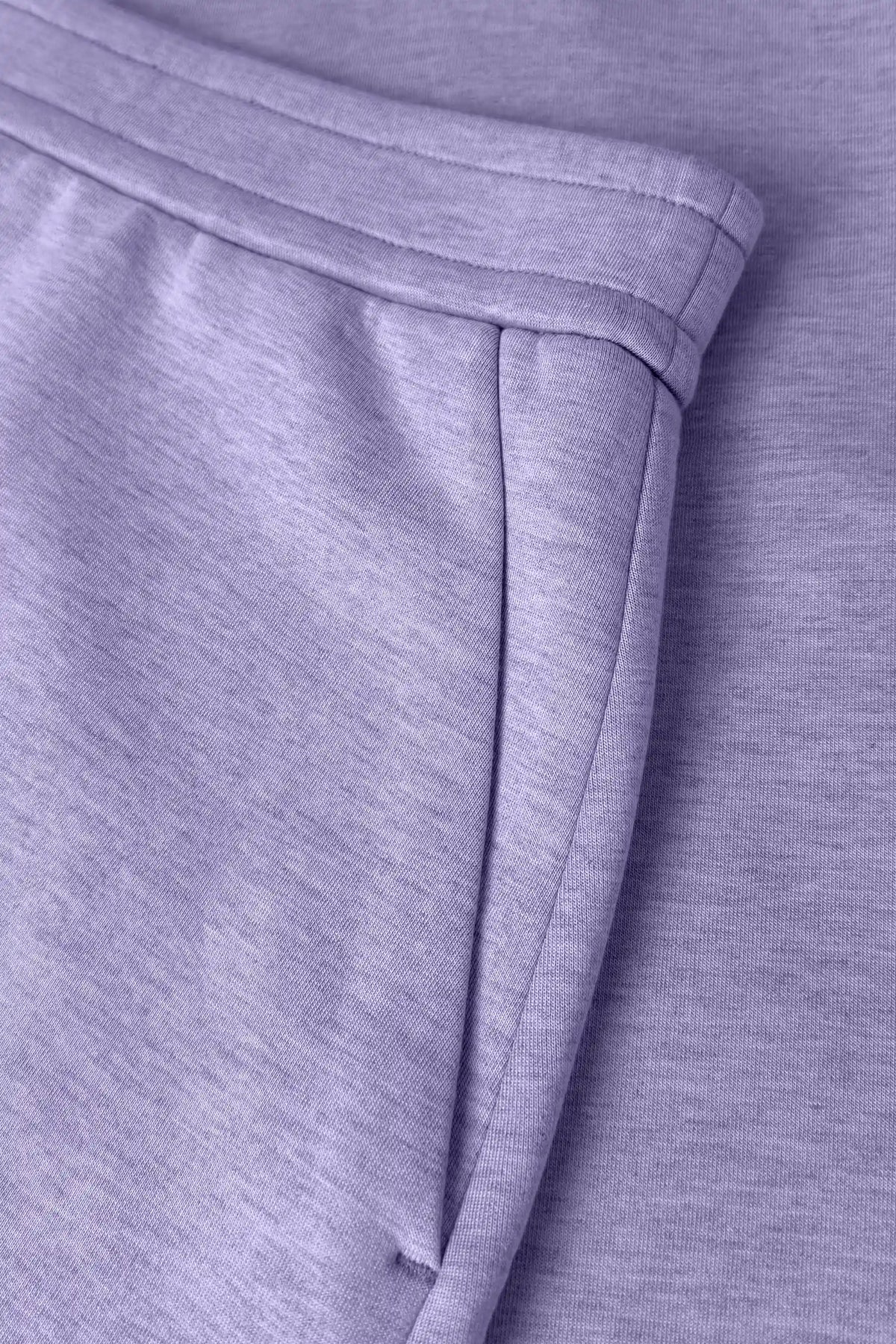 Close-up of women’s lavender wrap golf skort with structured waistband and side pocket detail