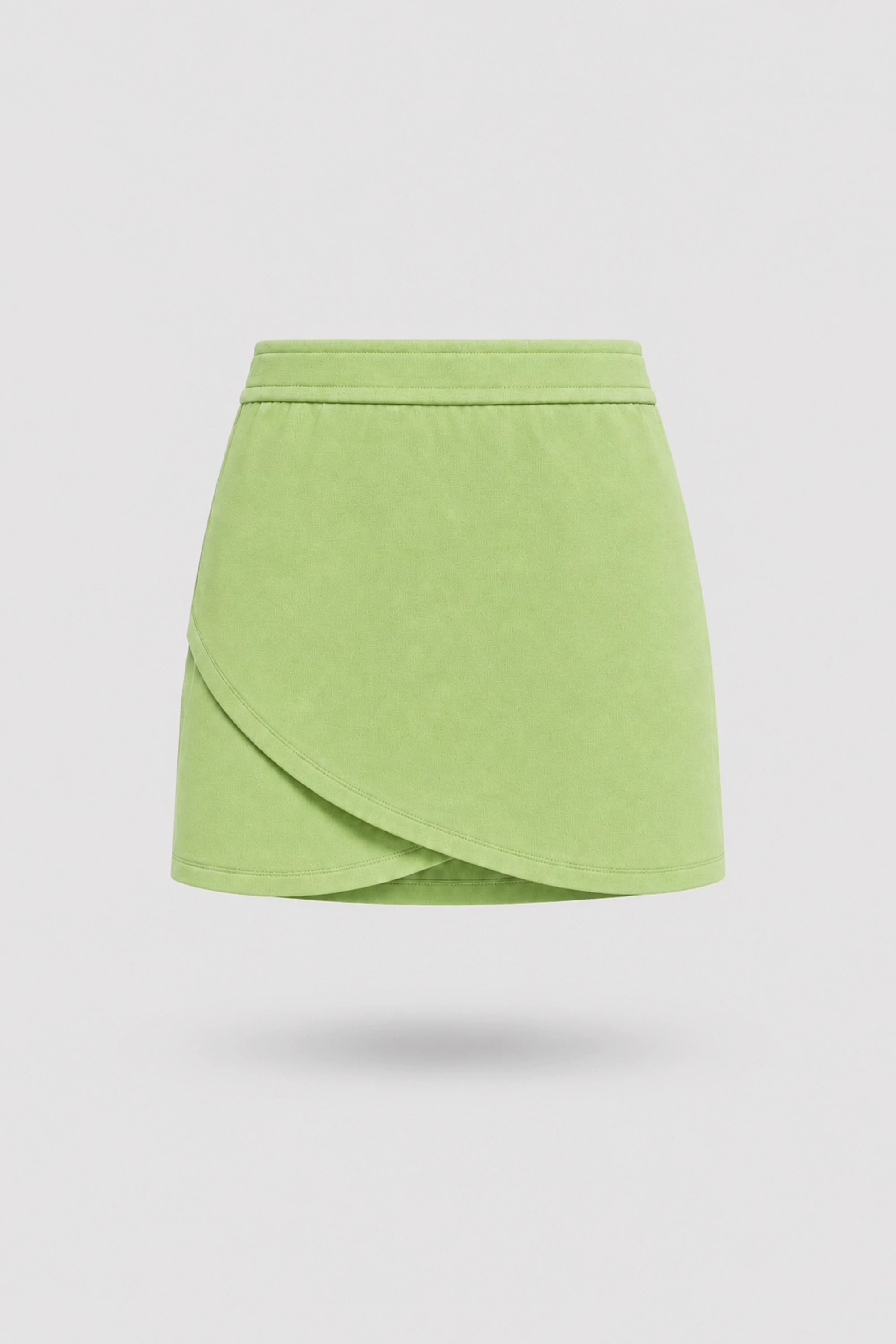 Women's wrap golf skort in lime green with sculpted silhouette and tailored fit